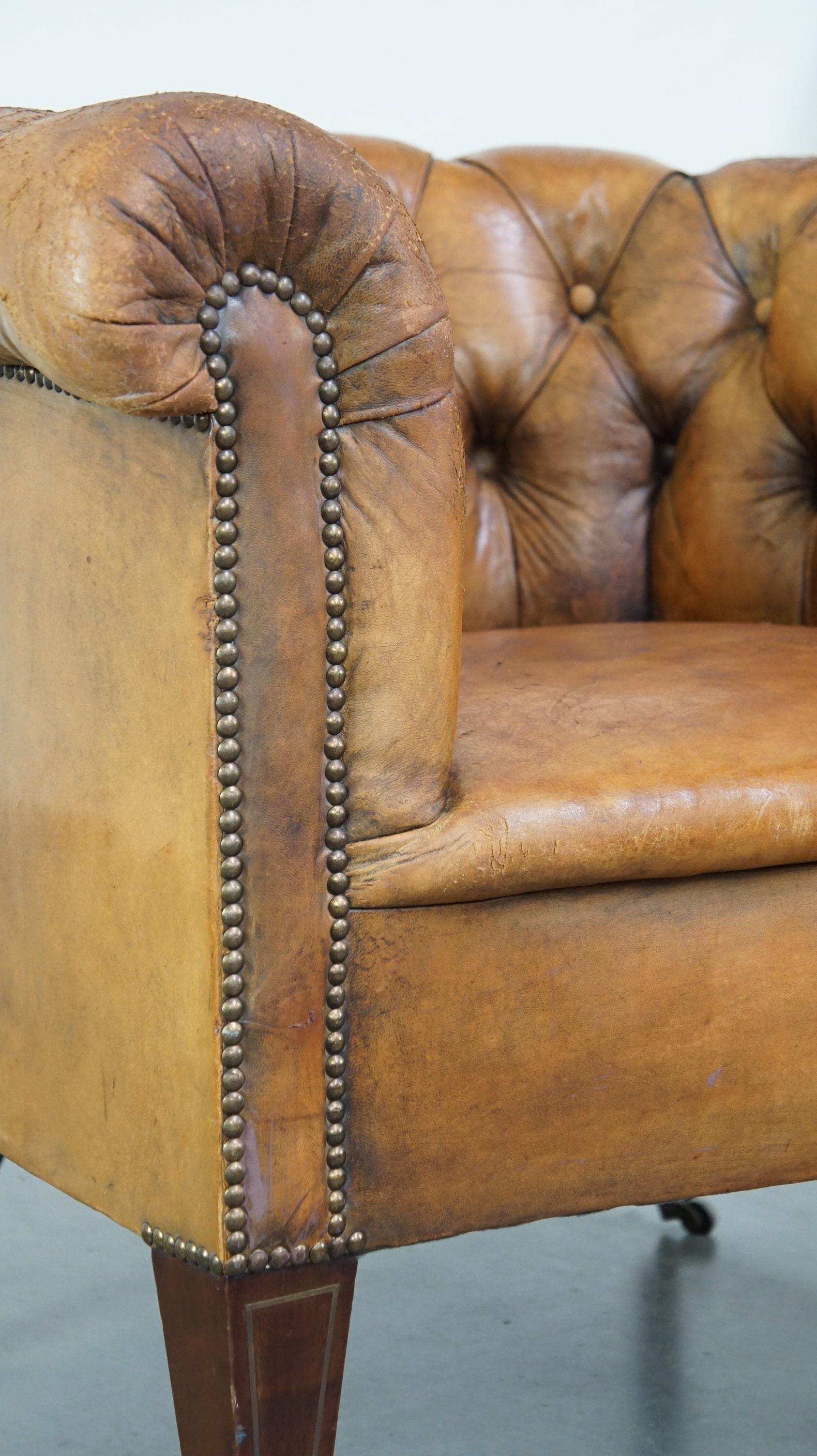 Antique, characteristic sheepskin chesterfield club chair on wheels For Sale 5