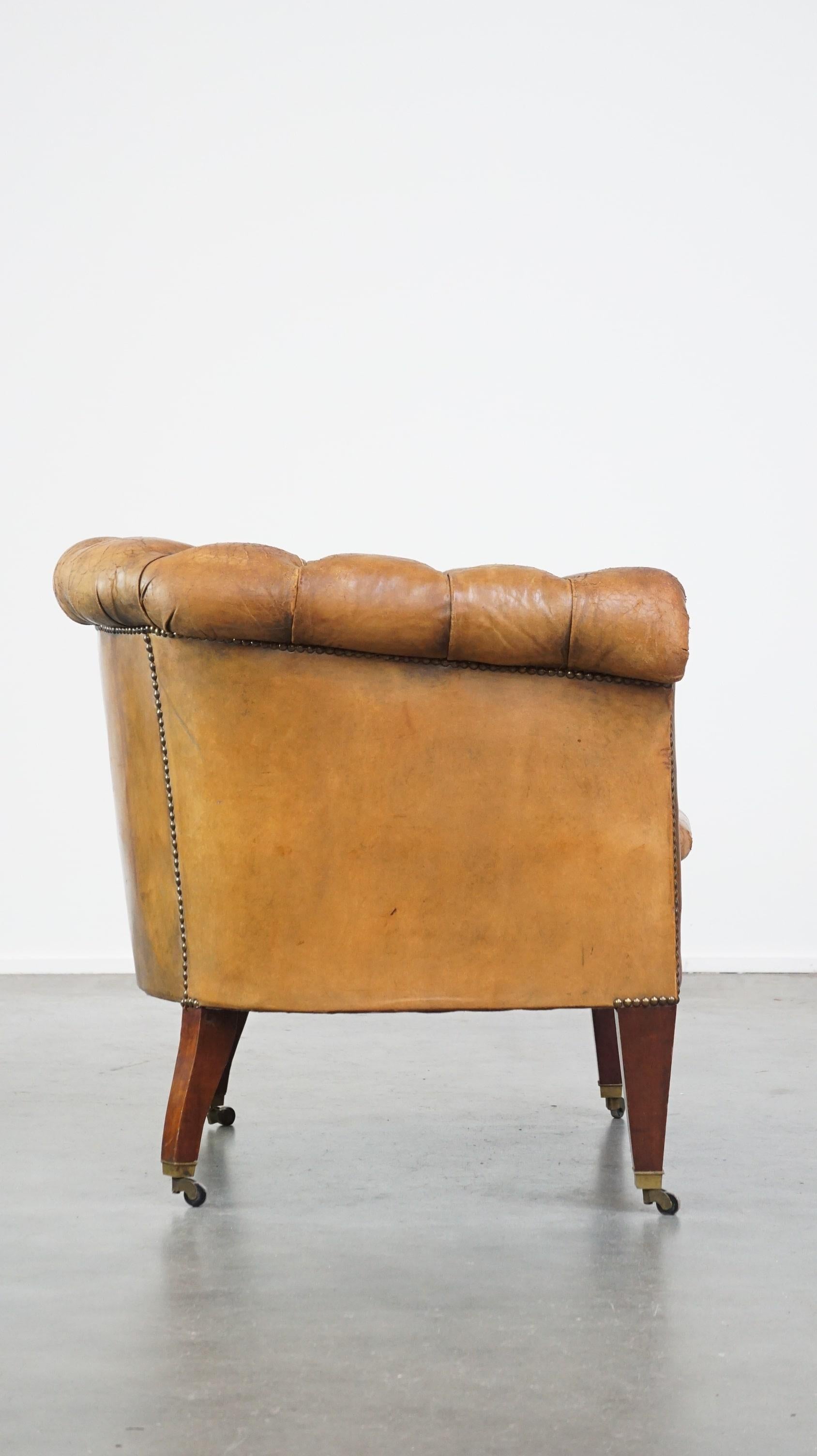 Dutch Antique, characteristic sheepskin chesterfield club chair on wheels For Sale