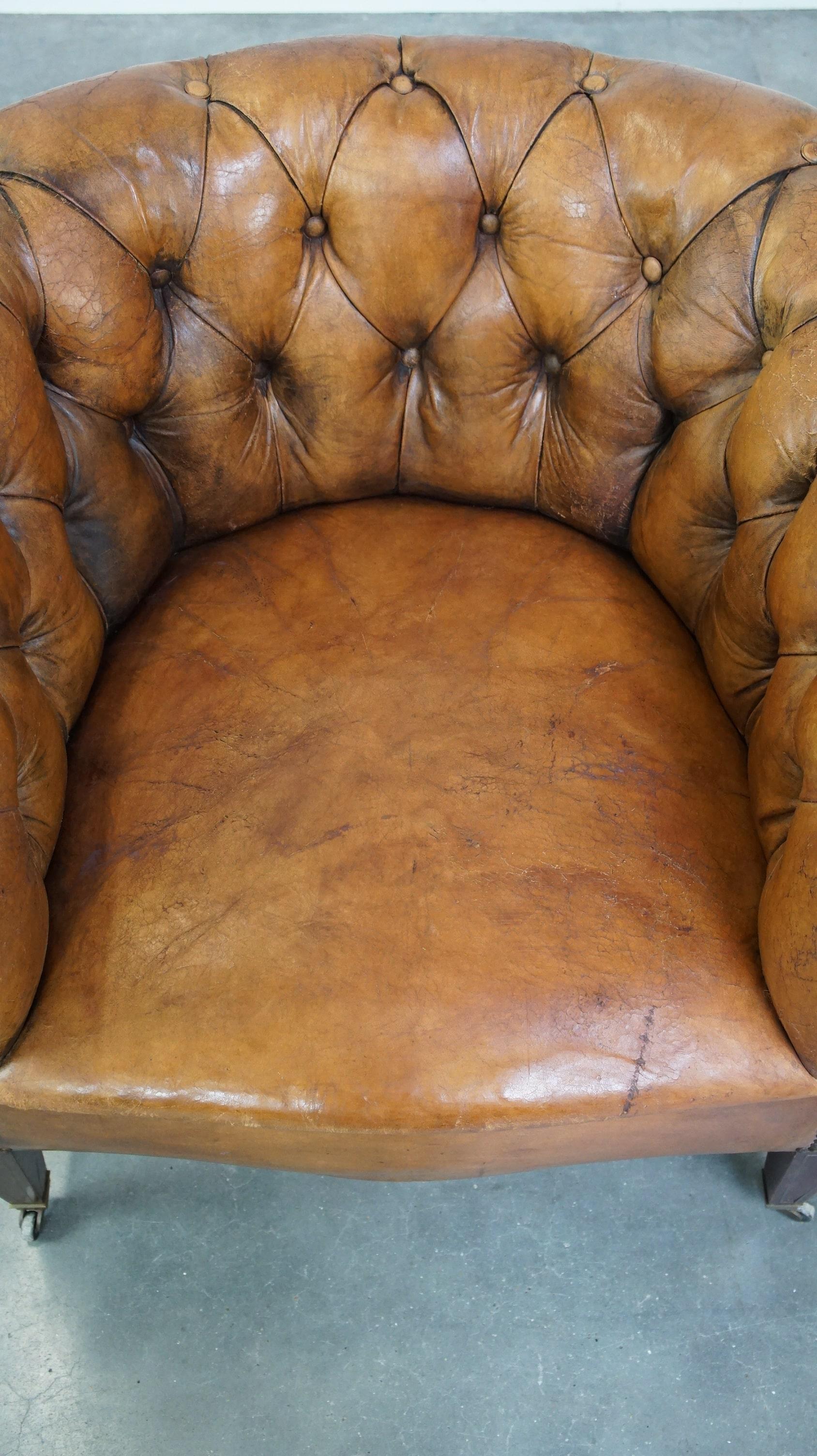 Contemporary Antique, characteristic sheepskin chesterfield club chair on wheels For Sale