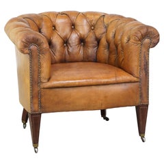 Antique, characteristic sheepskin chesterfield club chair on wheels