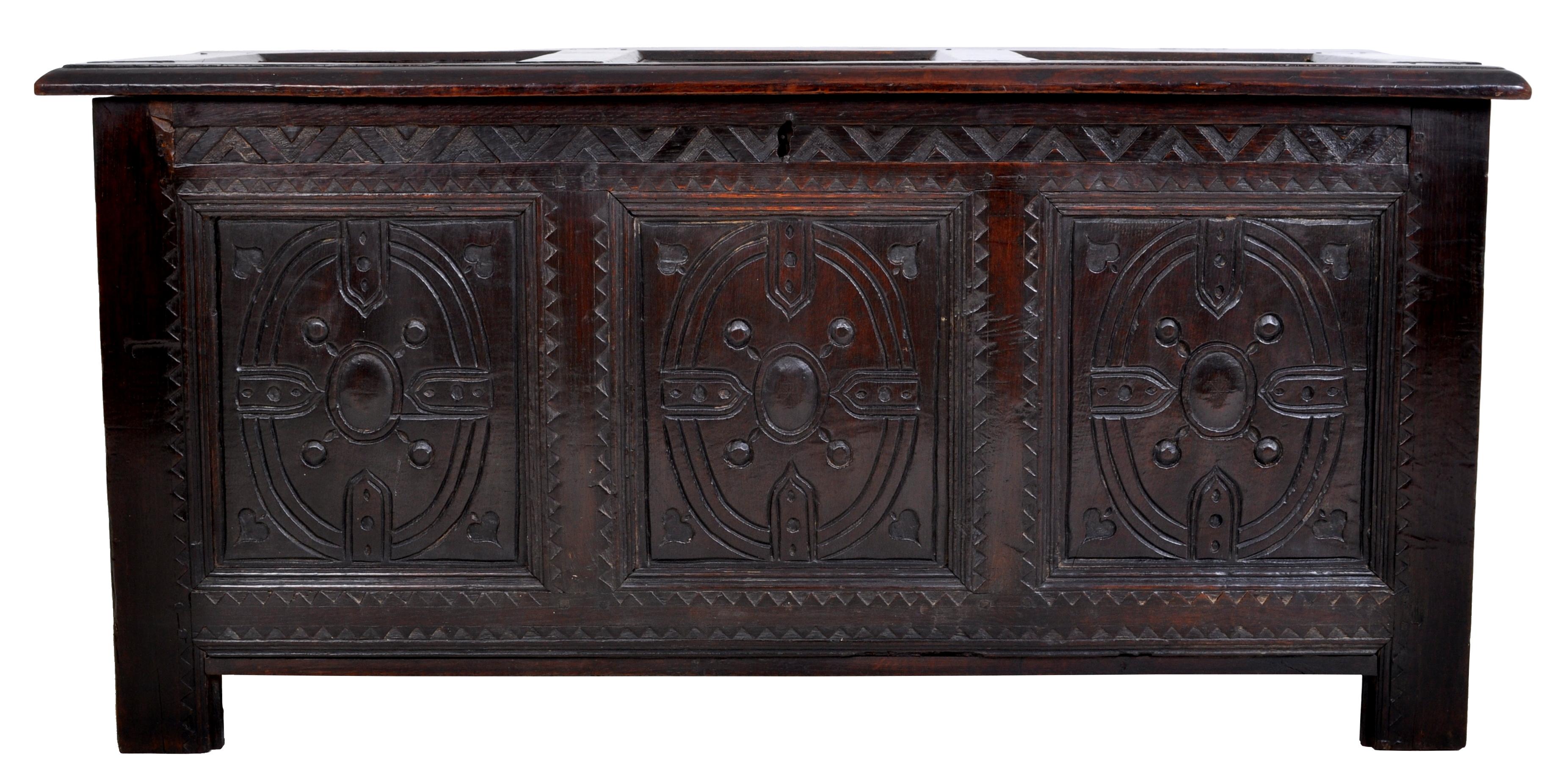 Antique Charles II carved oak coffer / chest / trunk, circa 1670. The coffer having a three-paneled top which corresponds to the three panels to the front, the front carved with oval geometric devices and a chevroned gallery above. The coffer being