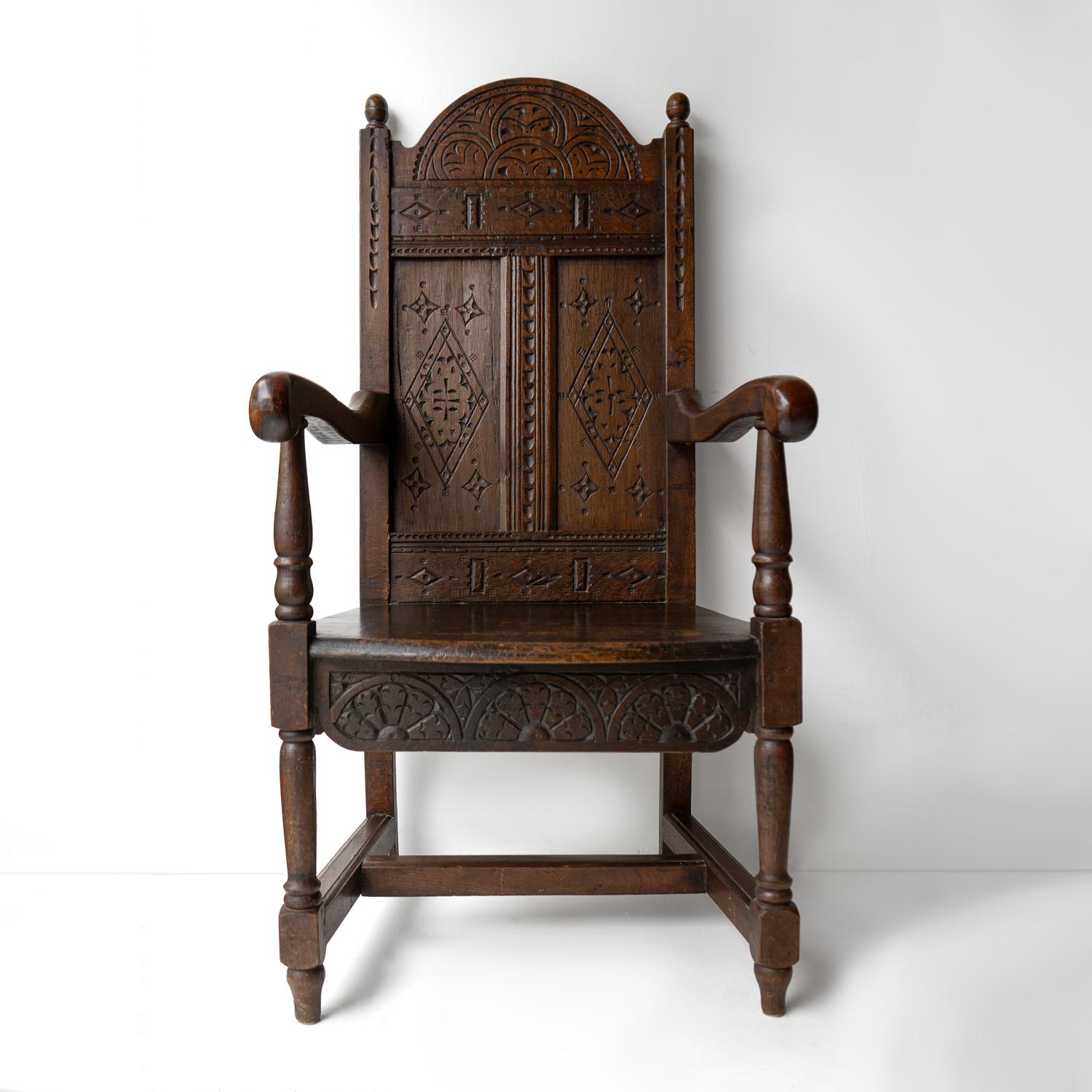 EARLY ENGLISH ANTIQUE CHAIR 
A generous-sized, handsome throne of chair which would grace all manner of interiors. 

An arched panel back with shaped arms, a solid seat with turned front legs and square back legs united by an ‘H’ frame