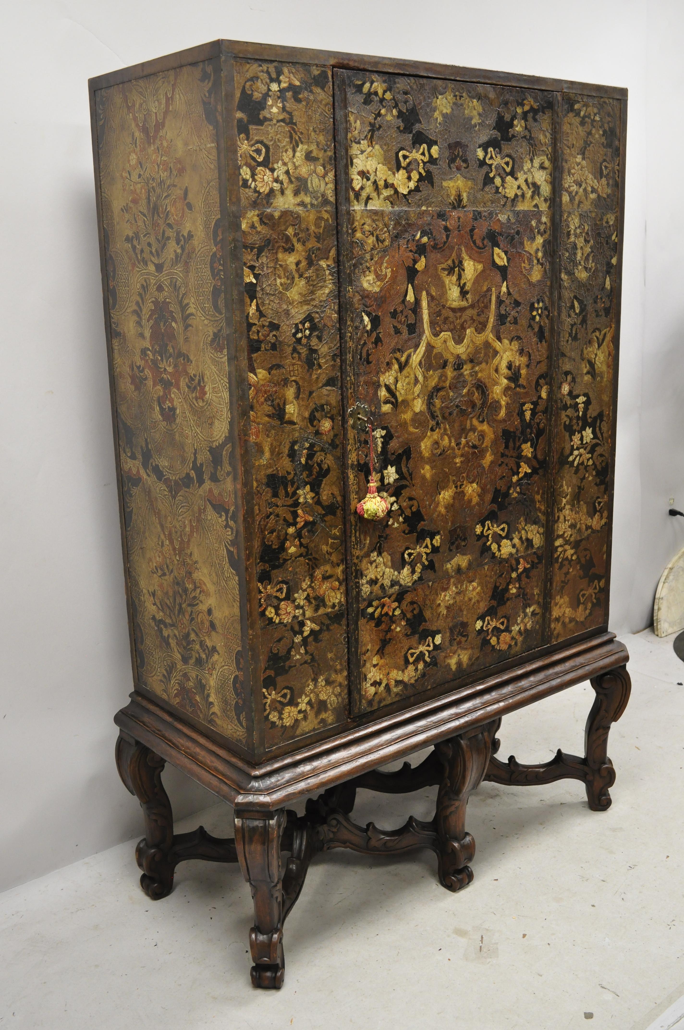 Antique Charles II Georgian Japanned carved lacquer China cabinet on base. Item features ornate lacquer decorated case, solid carved walnut stretcher base, red lacquer interior, leather trim, 1 swing door, working lock and key, 3 wooden shelves (1