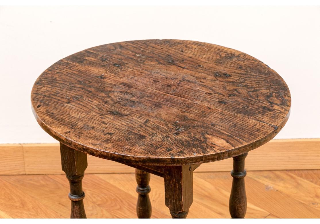 A very well made Oak Tavern Table with peg construction, turned supports and stretcher base. With a smooth time-softened hand, solid construction and great age patina. 

Dimensions: 23 1/2