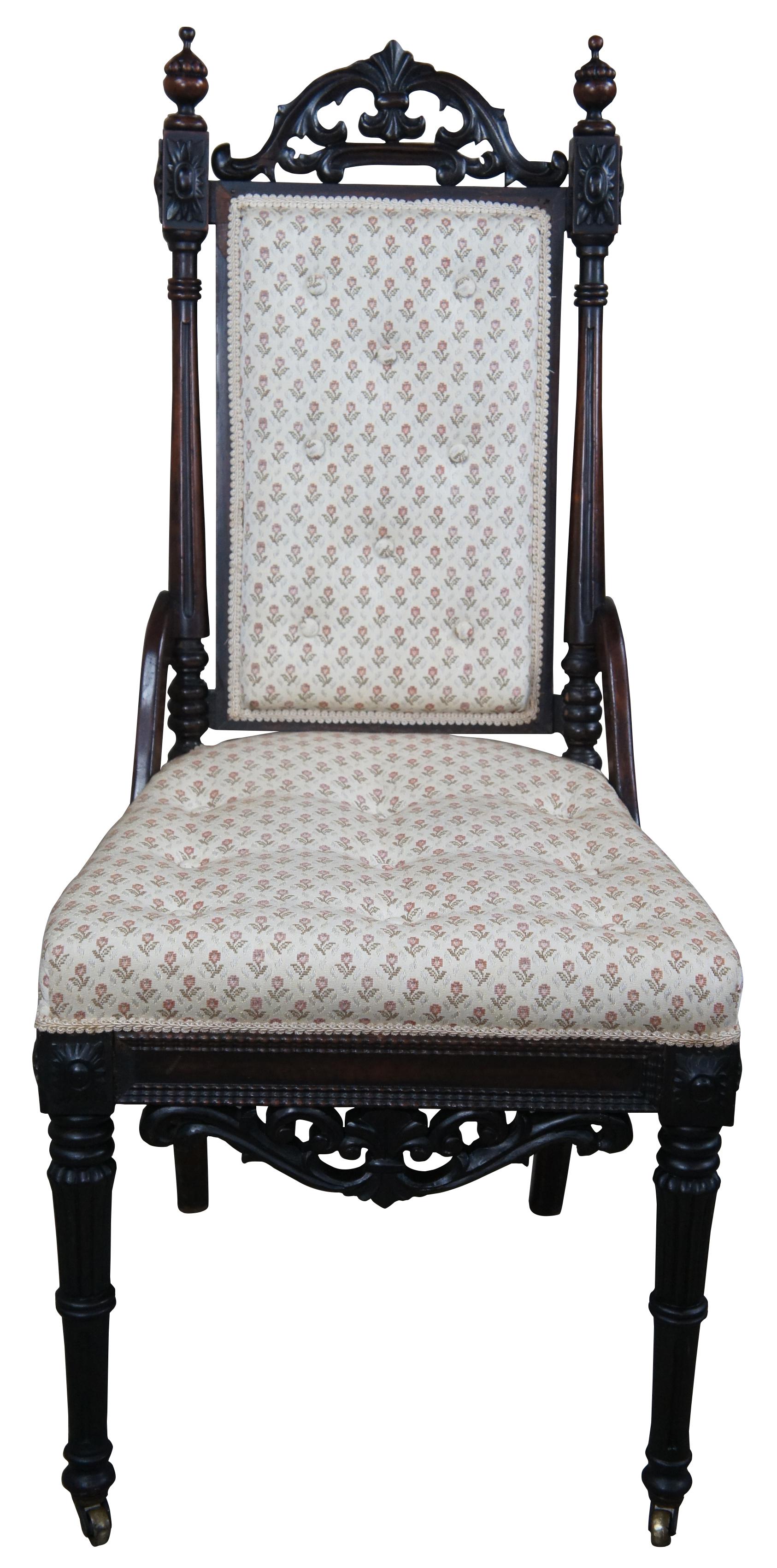 Victorian era Gothic side chair. Drawing inspiration from Charles II and French Renaissance Revival. Made from walnut with a pierced and carved Fleur crest set between carved block medallions and spire shaped finials. The chair features turned and