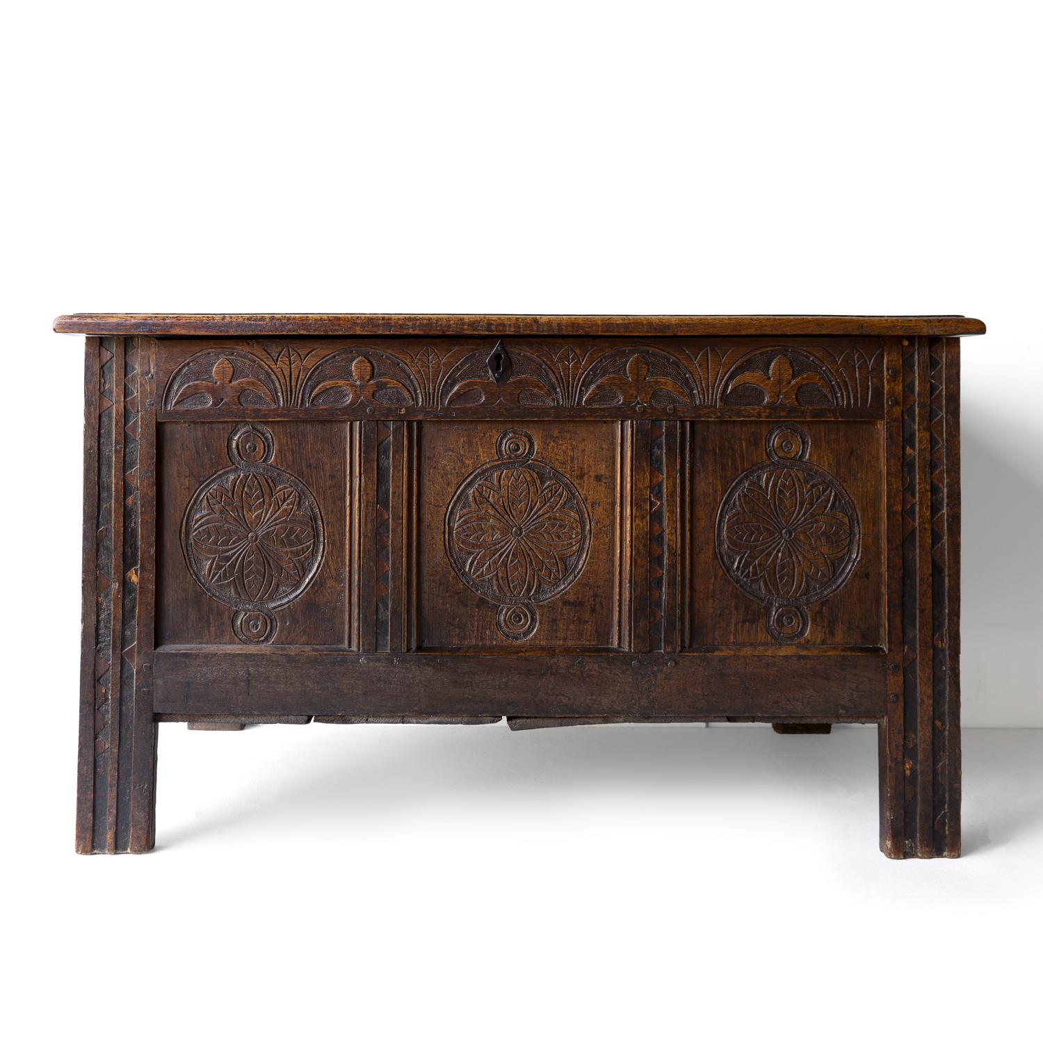 ANTIQUE PRIMITIVE OAK COFFER
A country-made piece with charming folk art style carving depicting stylised flowers, fans and geometric patterns.

Originating from the West Country, England.

Made from solid oak with a wonderful rich patina naturally