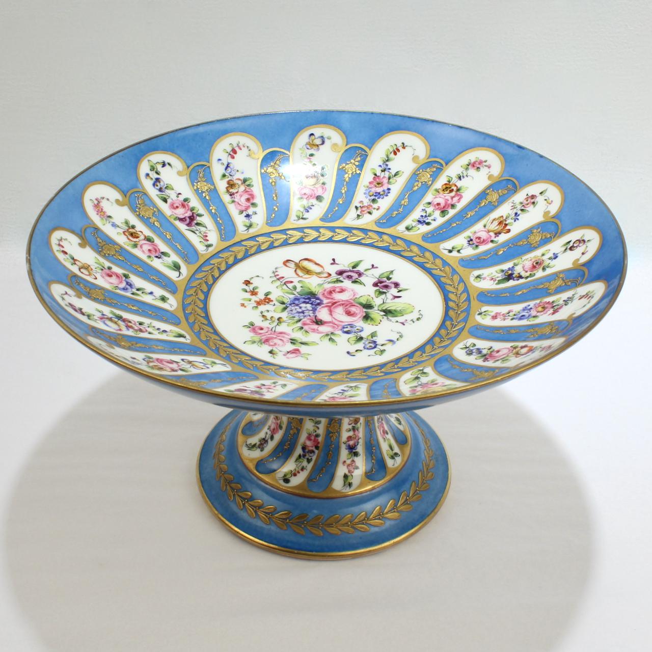A very fine antique French celeste bleu ground porcelain tazza or footed compote.

By Charles Pillivuyt & Co of Methun, France.

Decorated with a celeste bleu (or blue) powdered ground, raised gold decoration, and hand painted floral