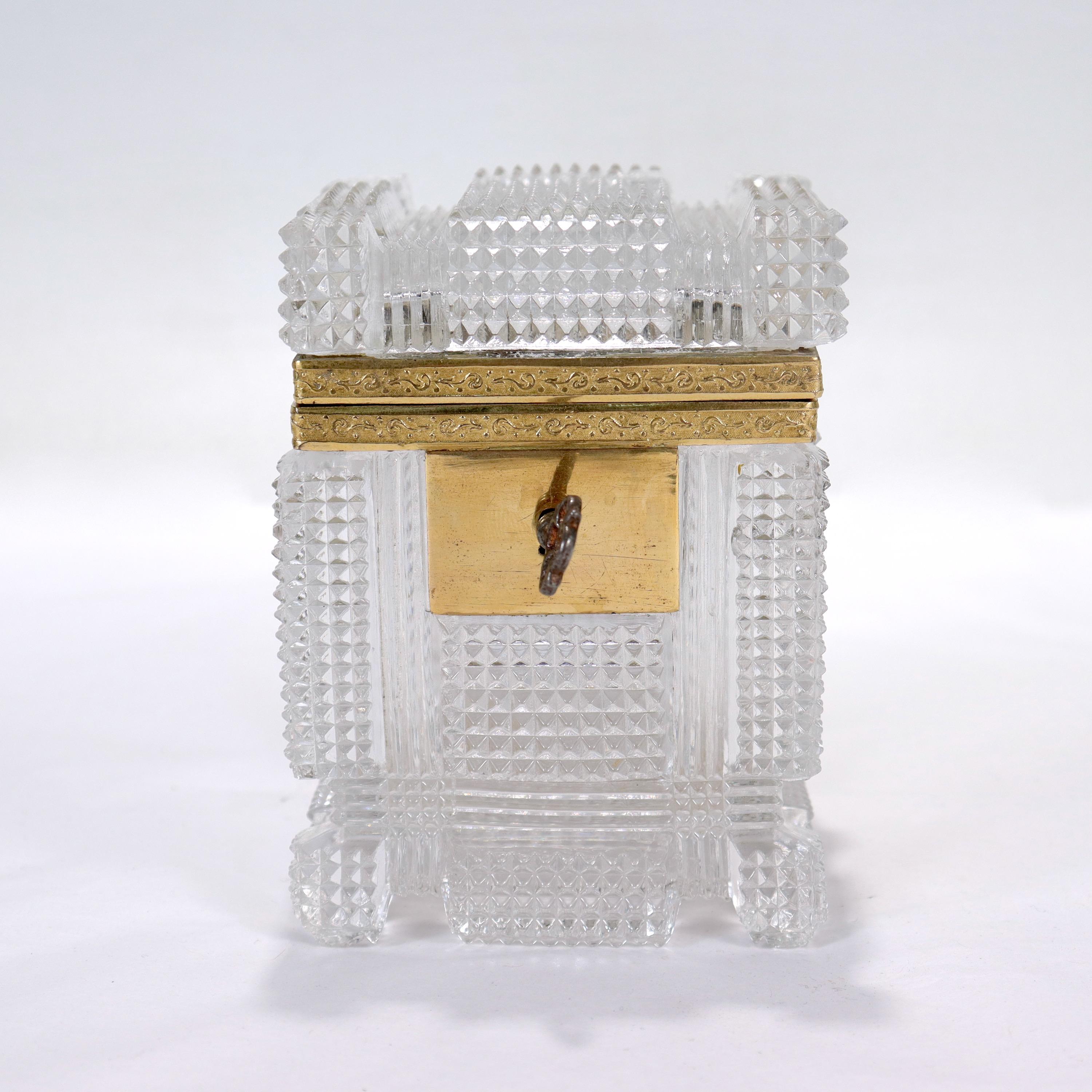 A fine antique French cut glass casket.

With a pressed and cut glass body and cover with a gilt bronze mount.

Together with an associated key for a nonfunctional lock.

Simply a great French cut glass casket!

Date:
Early 19th