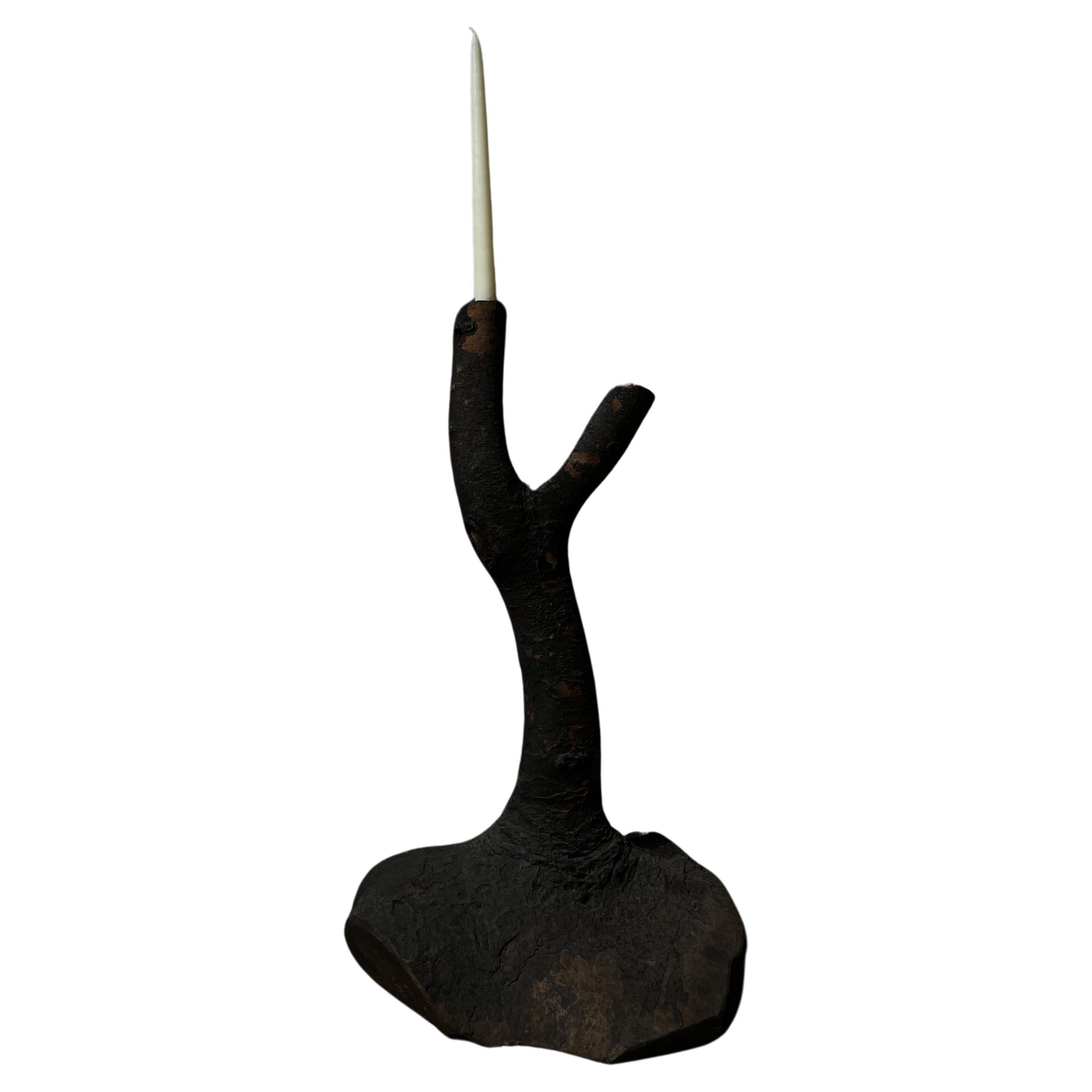 This antique charred wooden branch candle holder is recovered from an old fallen tree. It comes from an old traditional Japanese home with an Irori. An irori is a sunken fireplace in a center of a home. It is used to heat the home and for cooking.