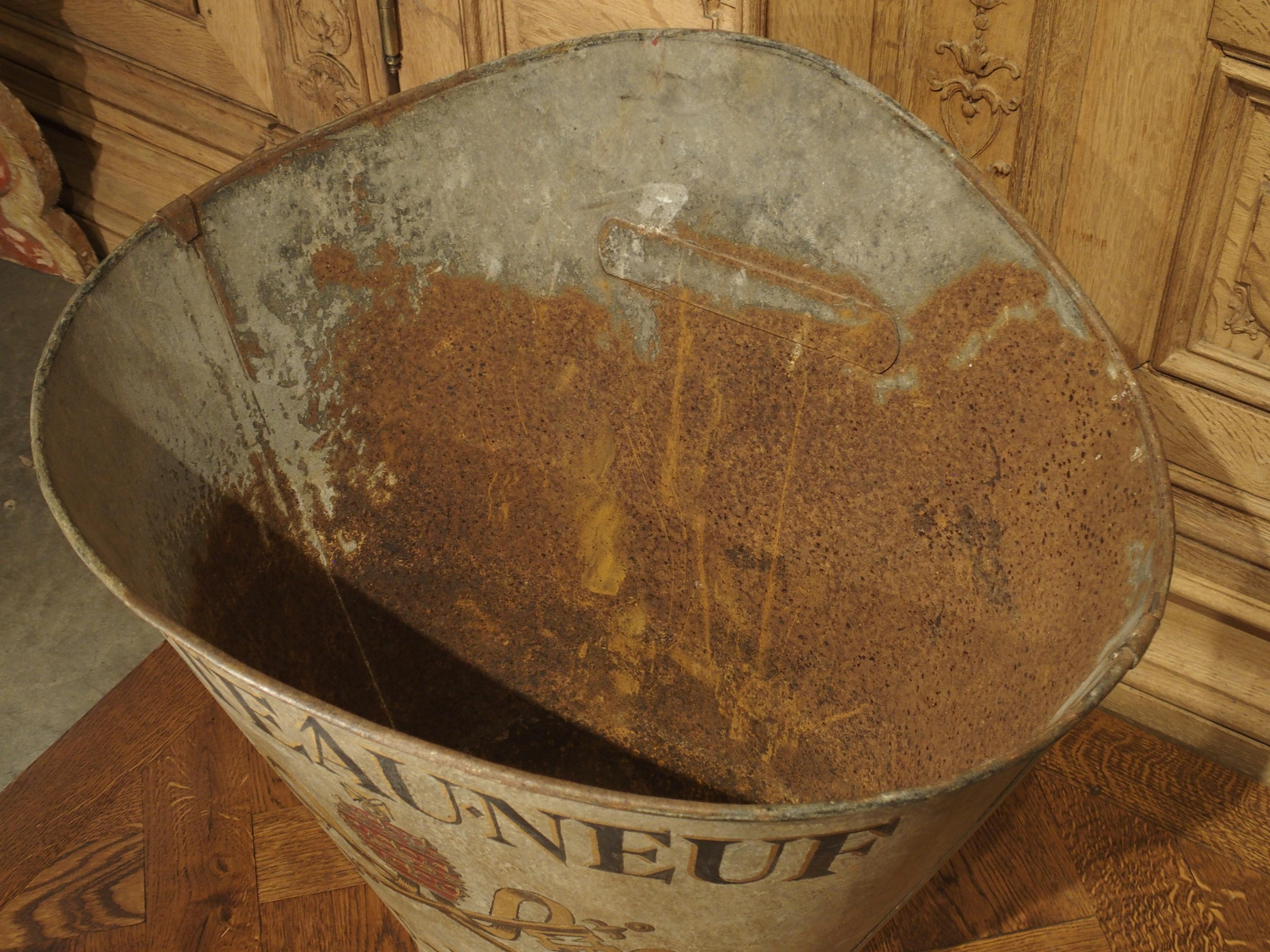 This French metal container is known as an hotte. Hottes were used during the 19th and early 20th centuries for collecting grapes in vineyards. The vineyard employee would attach the hotte to his/her back and place the harvested grapes directly into