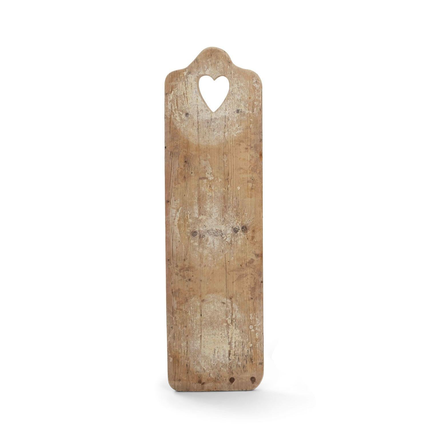 Antique cheese boards from France, dating to early 20th century. Heart-shaped handles carved into boards. Four available and sold individually, priced $795 each.

Note: Due to regional changes in humidity and climate during shipping, antique wood