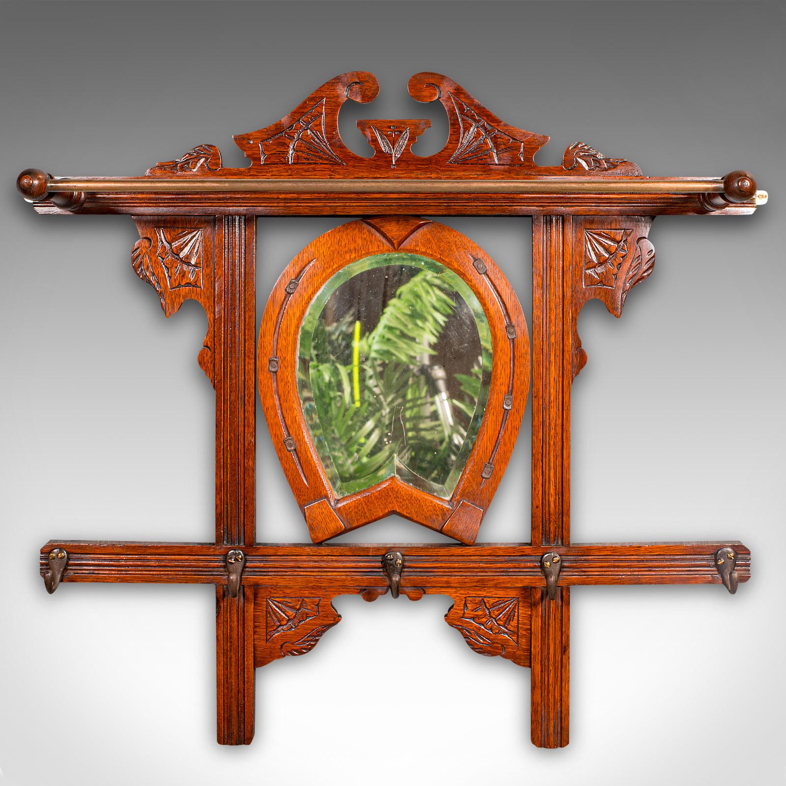 
This is an antique Cheltenham mirror. An English, oak and glass hall rack with equine overtones, dating to the Edwardian period, circa 1910.

Superb mirror, ideal for the hallway or a riding stables
Displays a desirable aged patina and in good