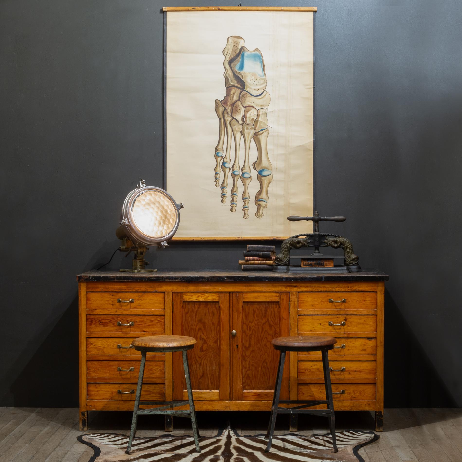 ABOUT

An early 20th century high school or university wooden chemistry class cabinet with 10 large ample drawers constructed with dovetail joinery. Large center cabinet with adjustable shelf. Original bronze pulls and large center bronze knob. The