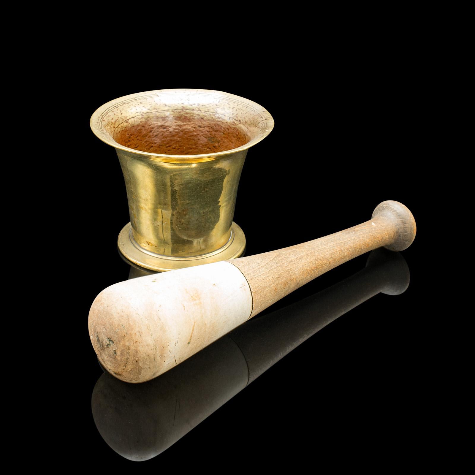 
This is an antique chemist's mortar & pestle set. A French, bronze apothecary aid with beech and ceramic pestle, dating to the late Victorian period, circa 1900.

Delightful French example with appealing pestle
Displays a desirable aged patina