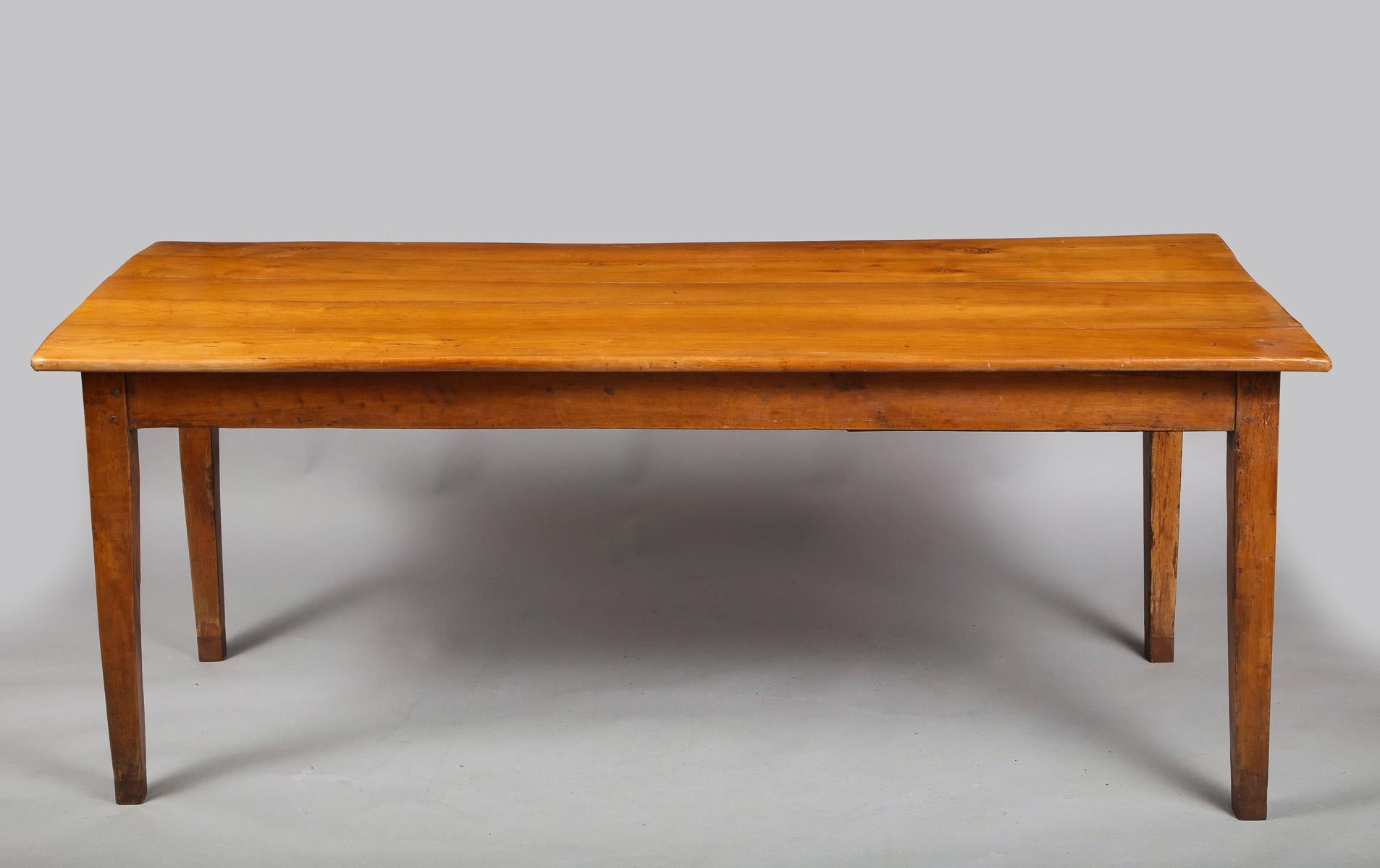 Good 19th century French cherrywood farm house table having drawer on one end and pullout / pull-out breadboard on other, standing on square tapered legs, the whole with pleasing color.

Height to apron on sides 25”.