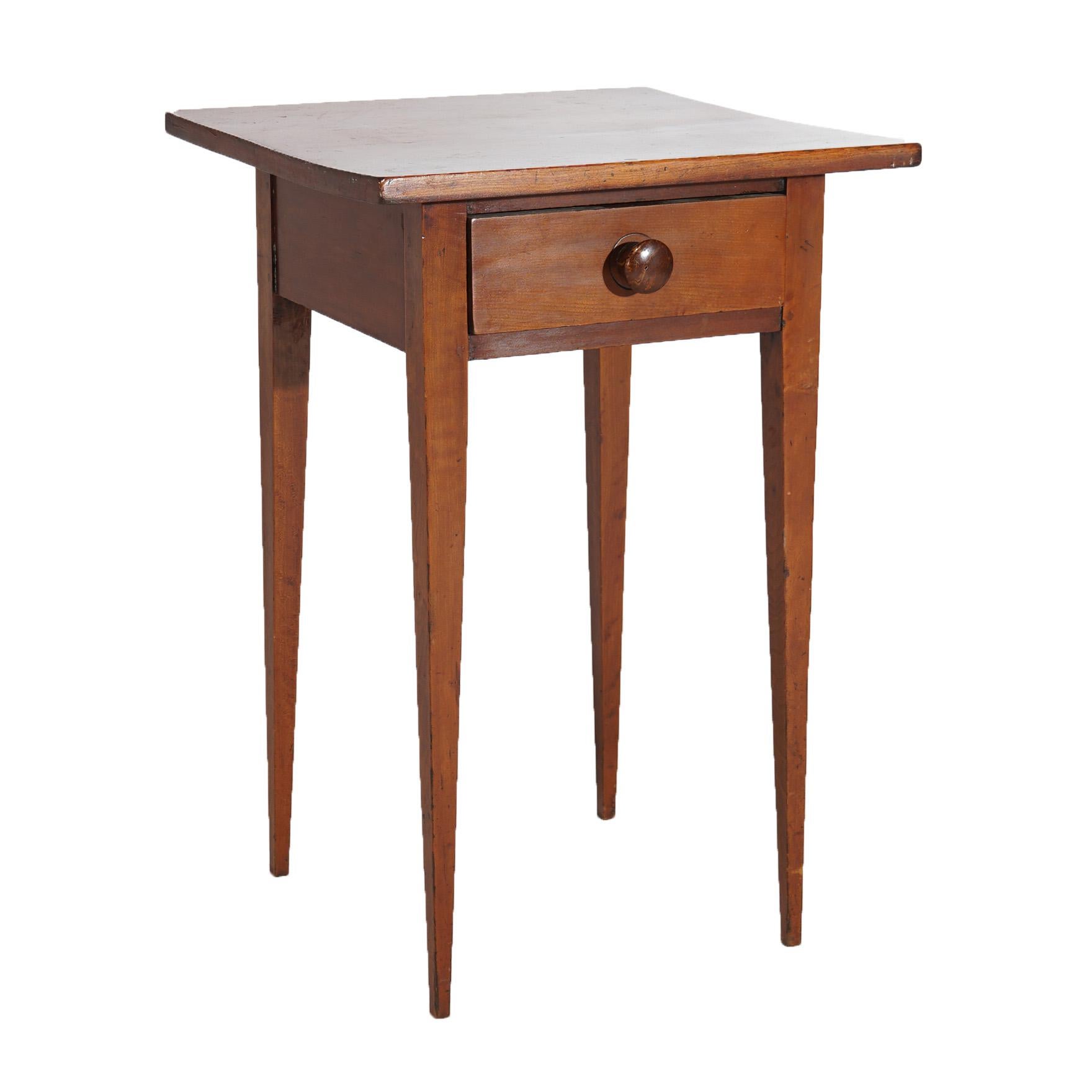 An antique Hepplewhite form side stand offers cherry construction with square top over single drawer case, raised on tapered straight and square legs, c1830

Measures- 27.75''H x 18.75''W x 18.25''D