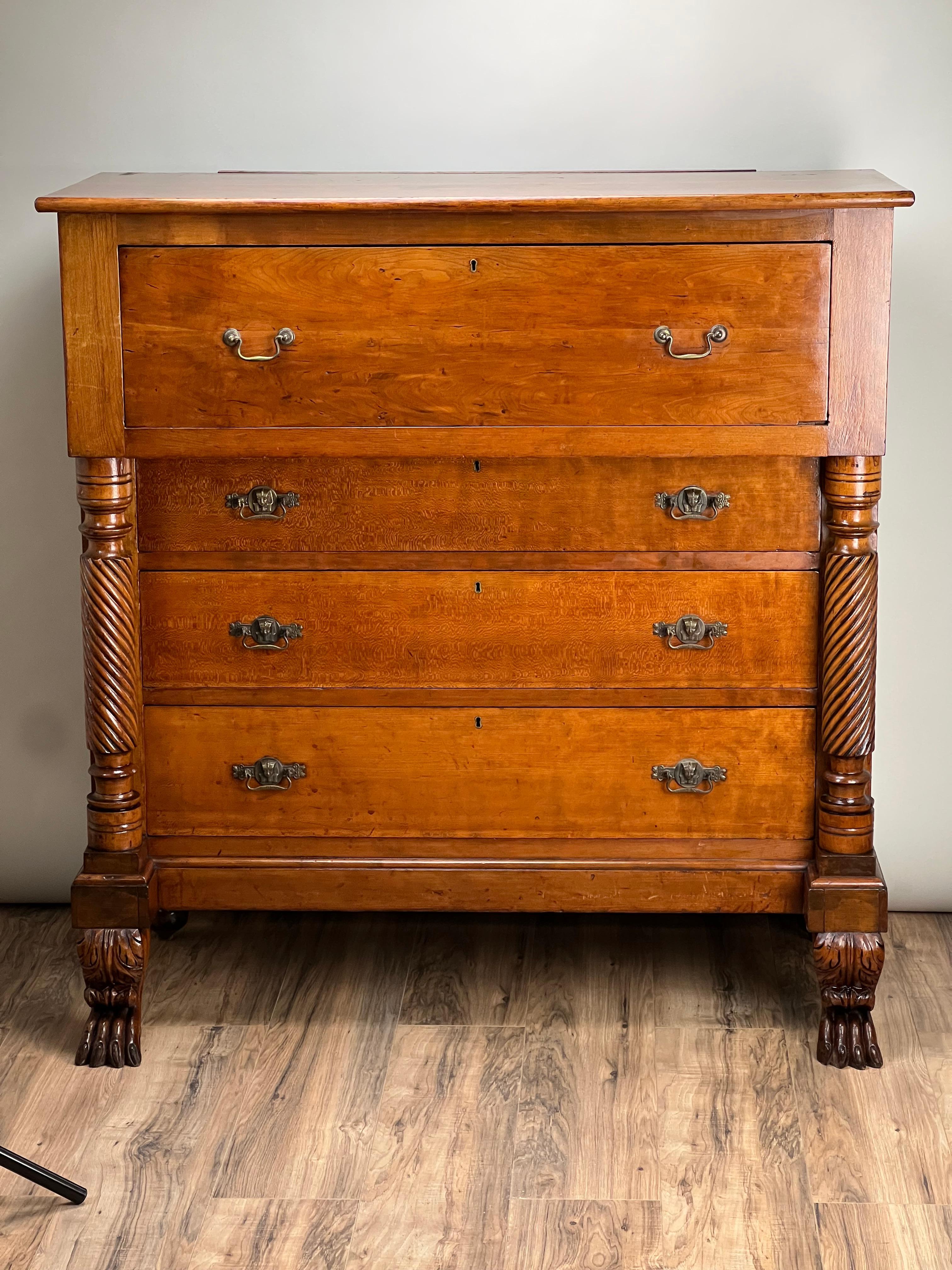 This Antique Cherry Late Federal Paw Foot Four Drawer Chest, dating to around 1840, is an exceptional piece of American furniture from the Federal period. Crafted from rich cherry wood, the chest has developed a deep, warm patina over time,