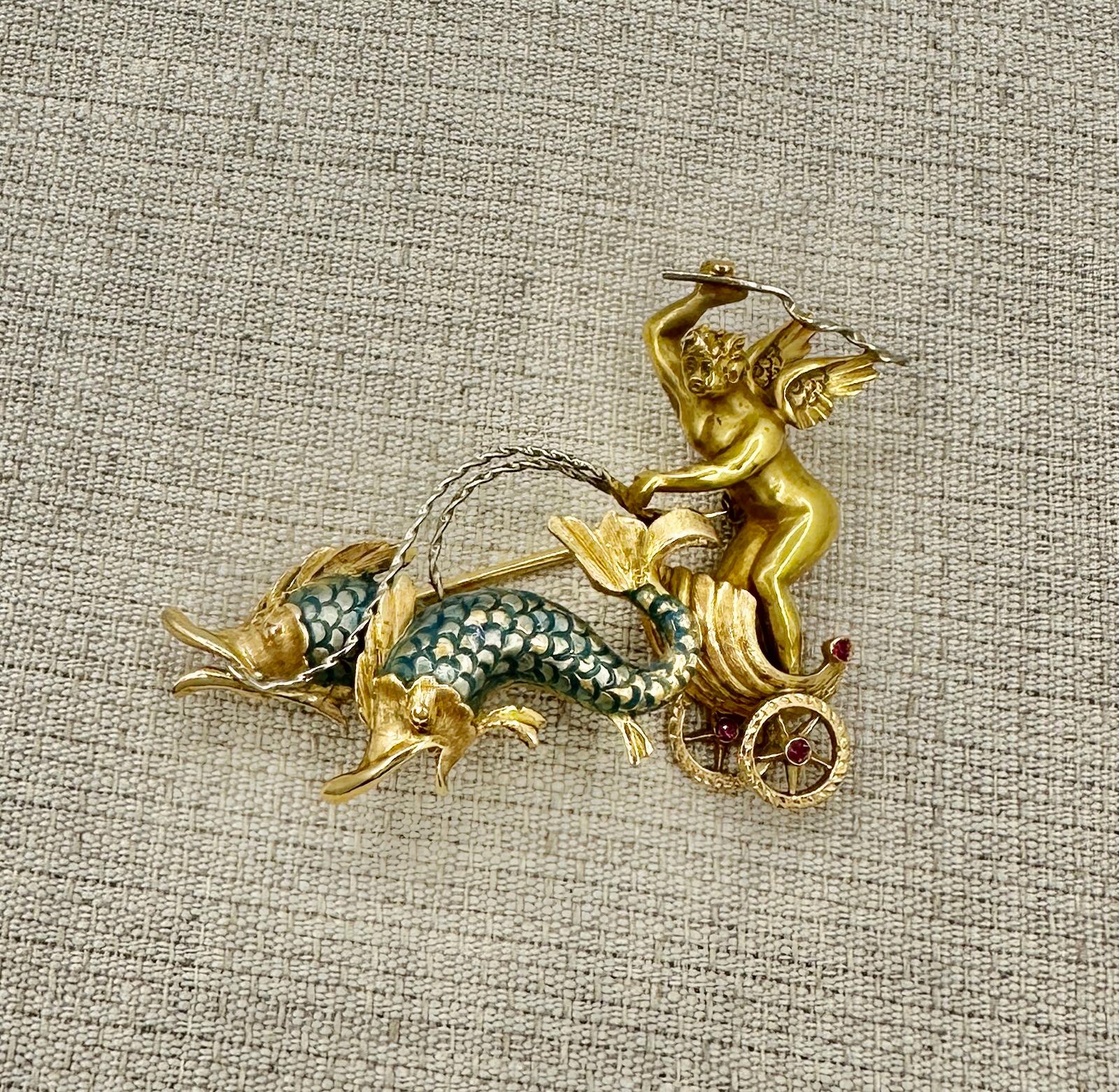 This is very rare and wonderful Antique Enamel Brooch Pin in 18 Karat Gold with a Winged Cherub or Angel Riding in a Dolphin pulled Chariot with gorgeous green-blue Enamel and three round Rubies.   The brooch has exquisite three dimensional design