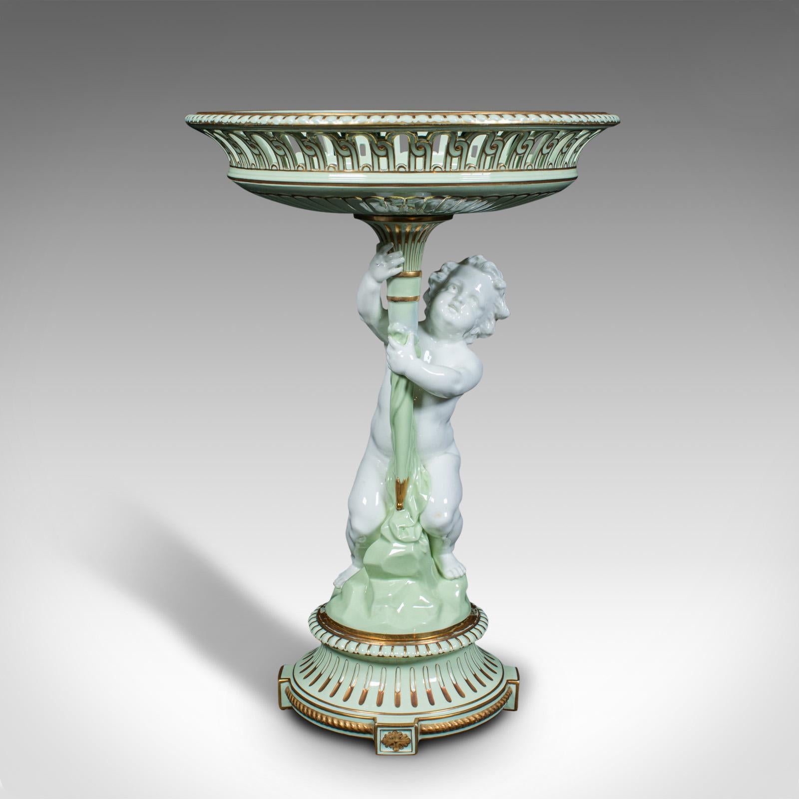 This is an antique cherub compote dish. An English, ceramic decorative putti grape bowl, dating to the Victorian period, circa 1880.

Of bold, cherubic form and generous proportion
Displays a desirable aged patina and in very good order
Ceramic