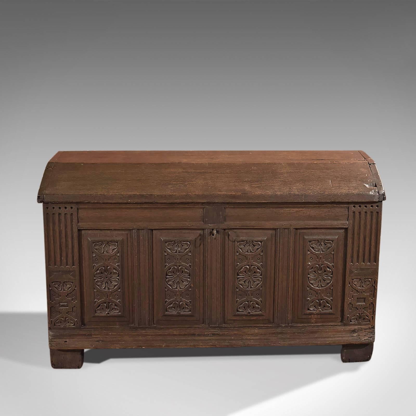 This is an antique chest dating to the late 17th century.

Raised on the extended stiles, this chest is of panelled construction held within robust 40 mm thick, oak stock displaying carved detail to the front; the four panels featuring stylised
