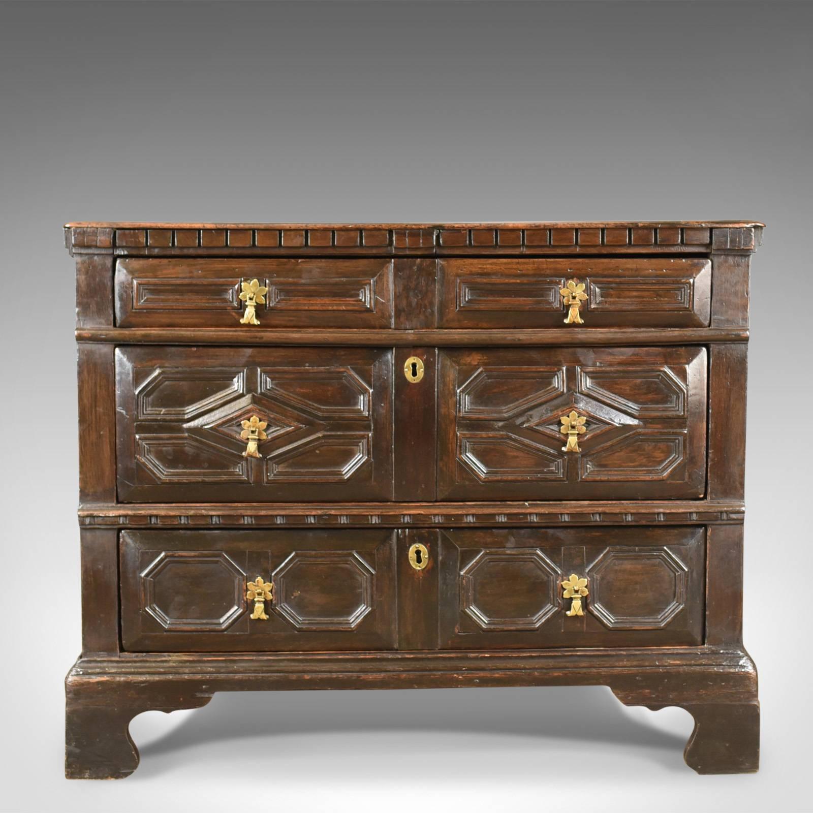 This is an antique chest of drawers, 17th century and later in English oak dating to circa 1690.

Classic 17th century styling in the geometric decoration
Desirable aged patina to the dark wax polished finish
Appealing proportions in the squat
