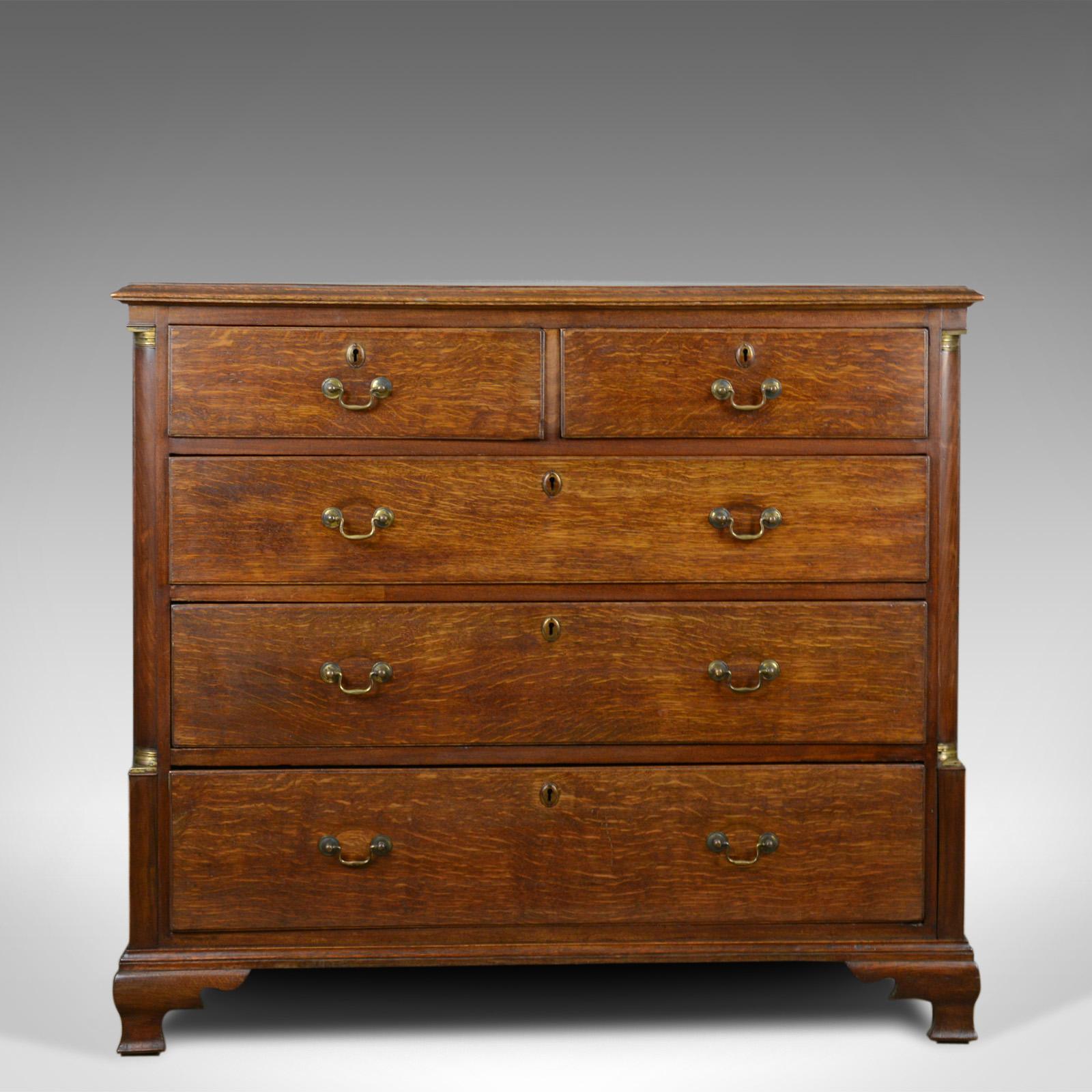 This is an antique chest of drawers in oak. An English, late Georgian tallboy dating to late 18th century, circa 1780.

Superb color and grain interest to the English oak
Wisps of medullary rays glow in the wax polished finish
Arranged in the