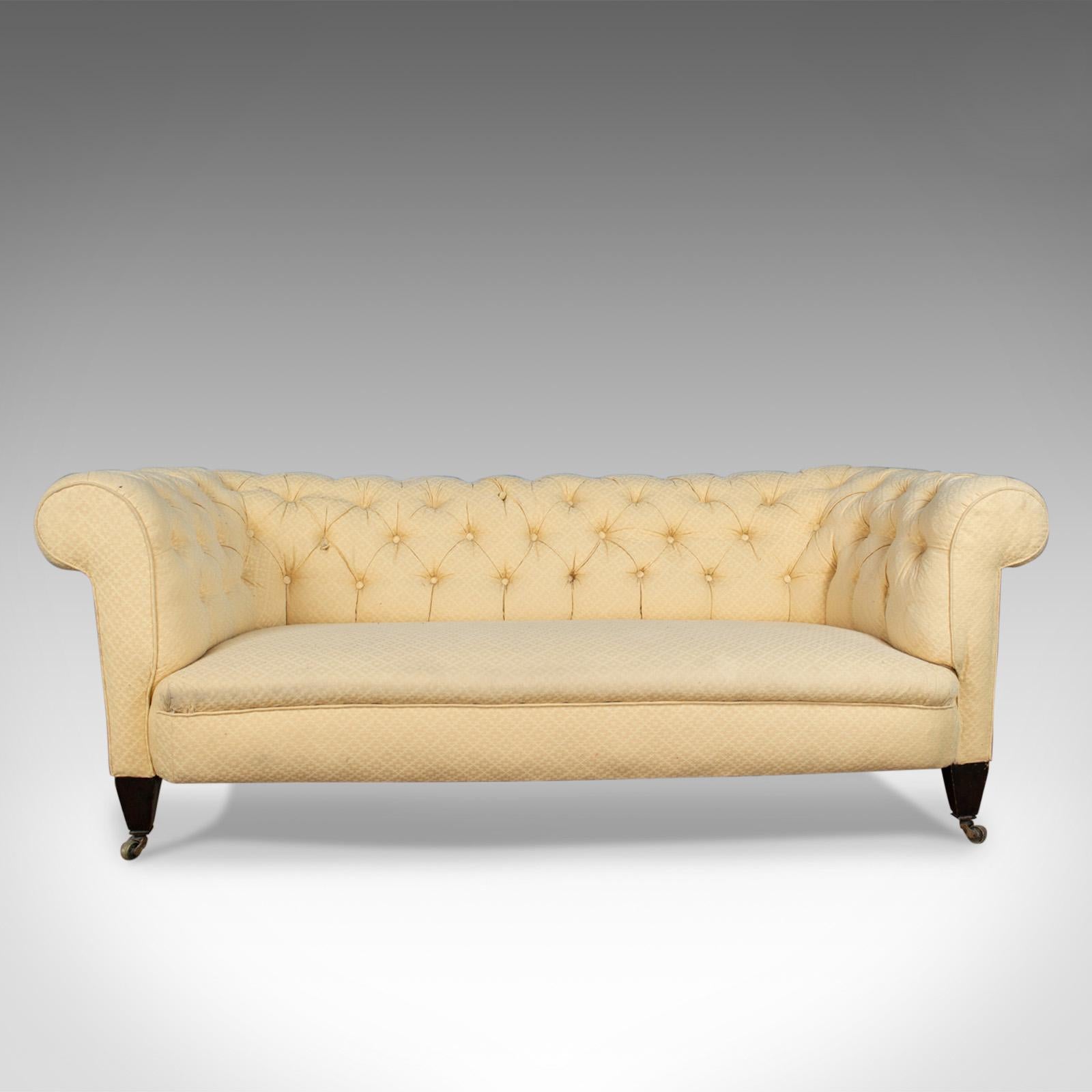 This is an antique Chesterfield sofa. An English, Victorian, three-seat settee dating to the late 19th century, circa 1890.

Attractive button back design with mahogany frame
Classic Chesterfield styling
Raised on stout, tapering legs to the