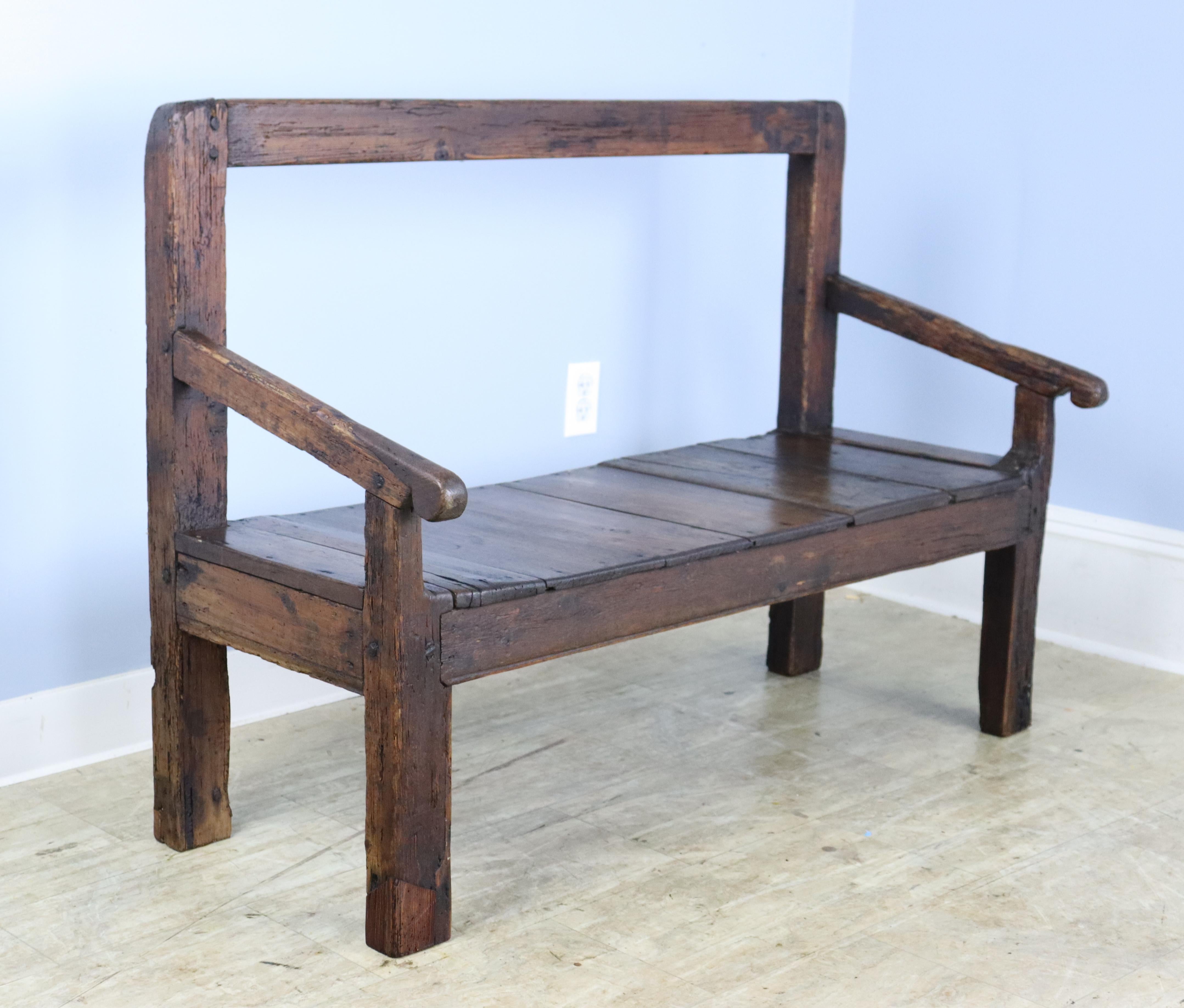 A rustic pine bench with a well grained chestnut seat. Lots of interesting distress and good original patina. Although seat height is somewhat low, this piece is very comfortable!