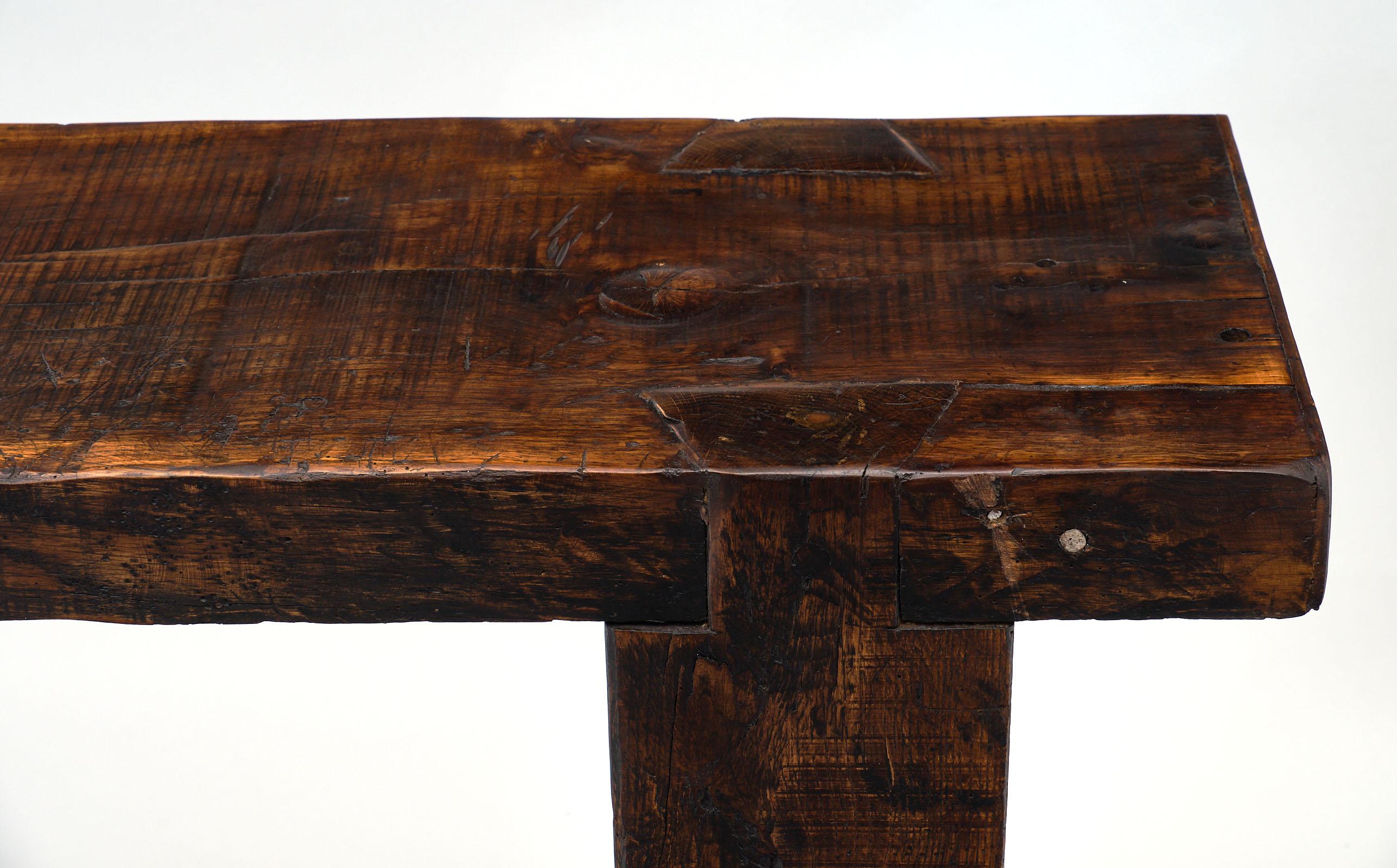Chestnut antique French workbench with a strong single plank top from the Swiss Alps. This table is made of solid chestnut featuring its original vise and bottom shelf. There is lots of character to this excellent piece, perfect to enhance your city