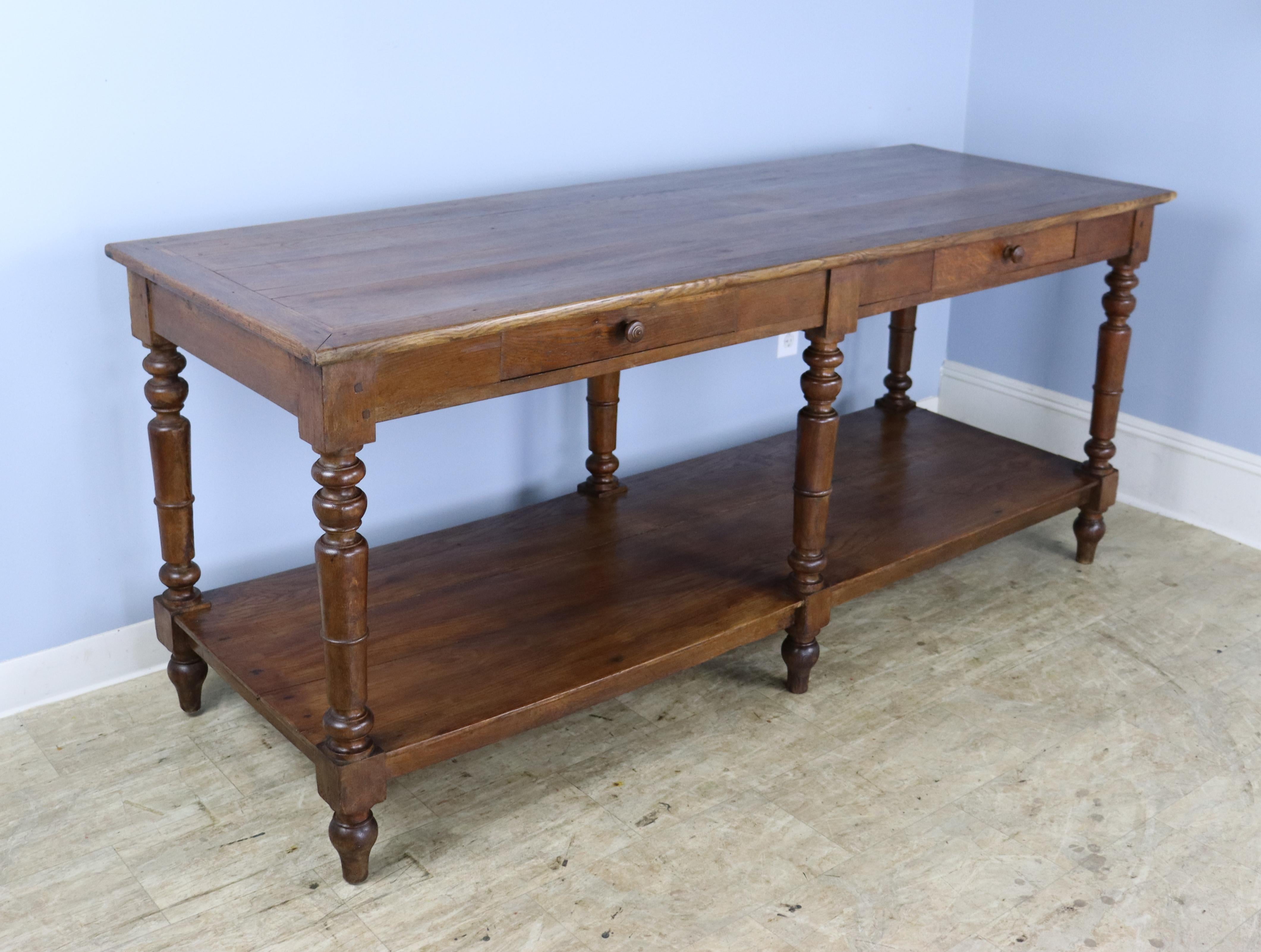 A fabulous French chestnut draper's table, originally for use by a tailor or seamstress. Legs have good turned detail and nice patina. Top has a smooth clean look, with some small areas of wear and two 19th century patches, shown. Would work well as