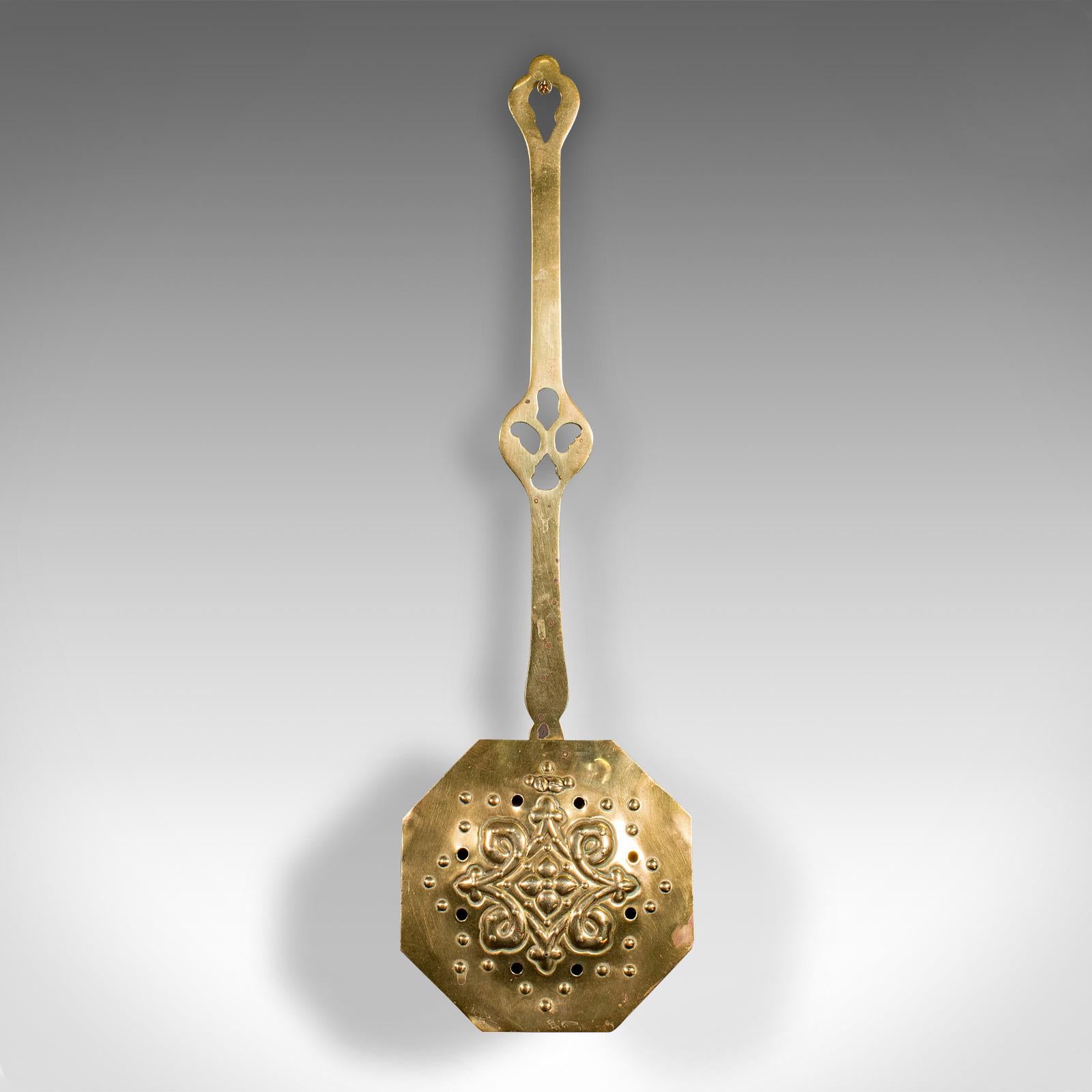 This is an antique chestnut roaster. An English, brass hanging warmer, dating to the Georgian period, circa 1800.

Appealing chestnut warmer with tasteful decor
Displaying a desirable aged patina throughout
Brass presents golden tonality with