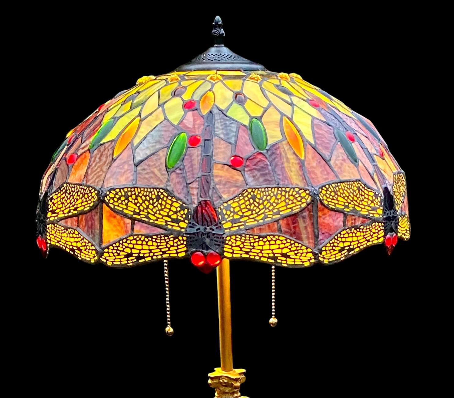 An antique 1920’s Chicago shade company, burnished gold Floor lamp with a first quality Tiffany style dragonfly shade. Sarcophagus prisms hanging from the original ring. 