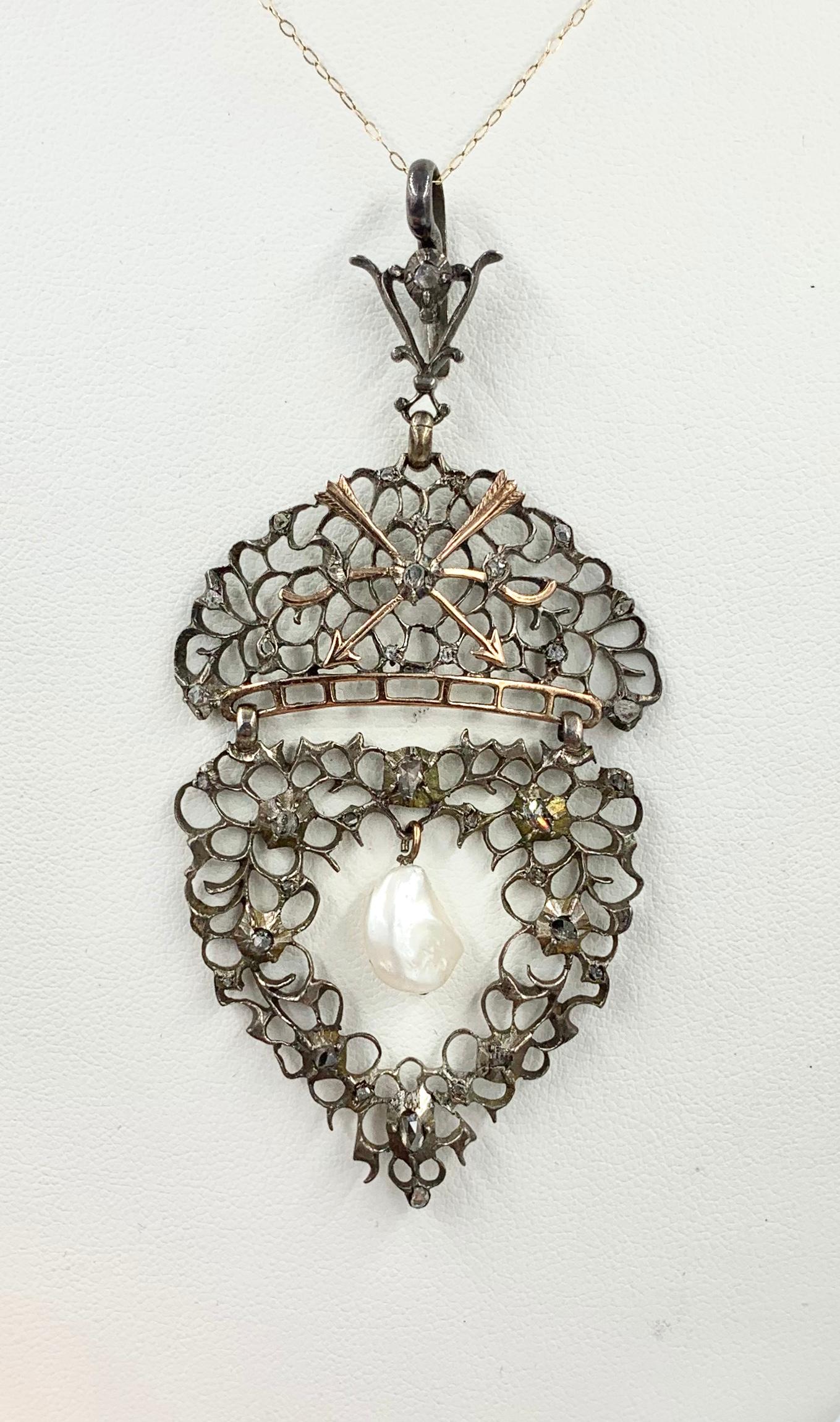 This is a spectacular Museum Quality Antique Pendant in the Renaissance Revival style set with Rose Cut Diamonds and a central hanging Baroque Pearl made by the acclaimed British jewelers, Child & Child (1880-1916), of London.  The pendant remains