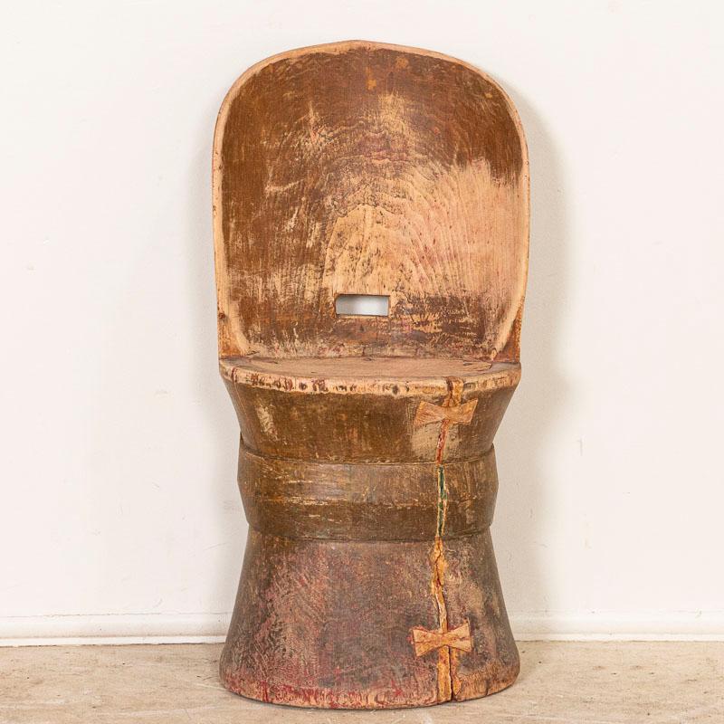 A kubbestol is a traditional Scandinavian chair made from a log. This one is a rare find due to its small scale as was made for a child. Every knot, crack, and sign of wear adds to the intriguing appeal of this hand-hewn stool. Notice in the photos