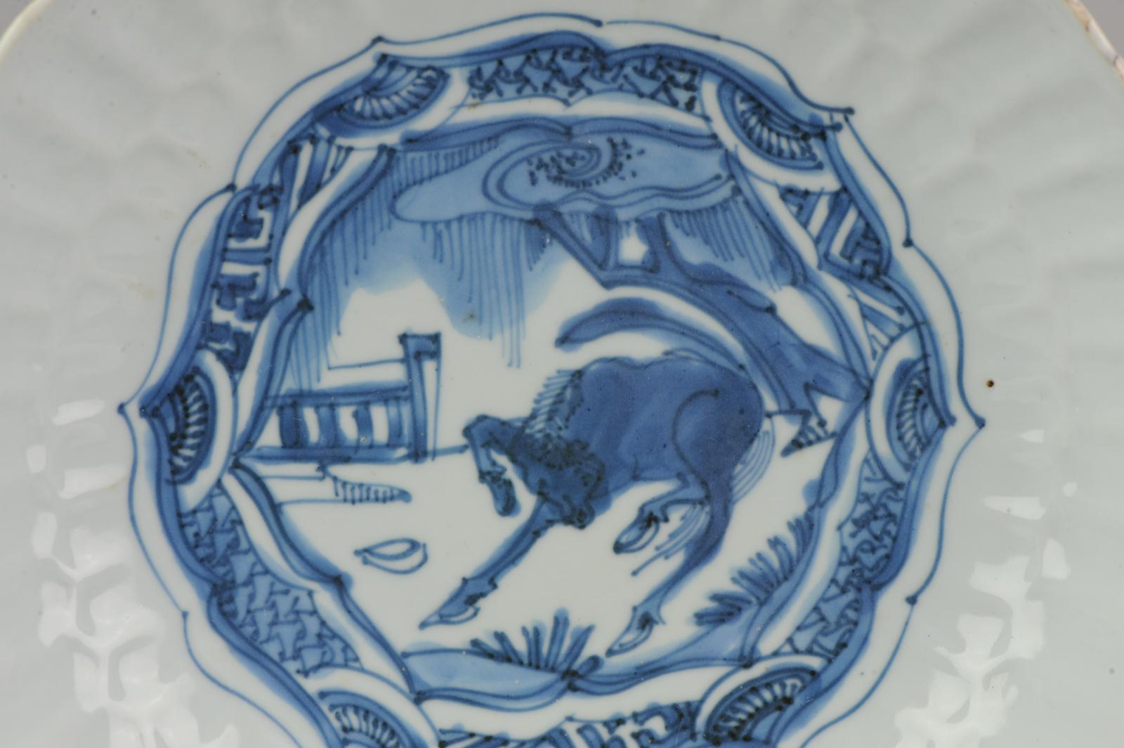A very nicely decorated plate with a horse in a landscape or garden scene (you see a part of a fence to the left). The scene is overlapped by typical Kraak diaper panels.

With a nice moulded double chrysanthemum rim.

Wanli, Tianqi or Chongzhen