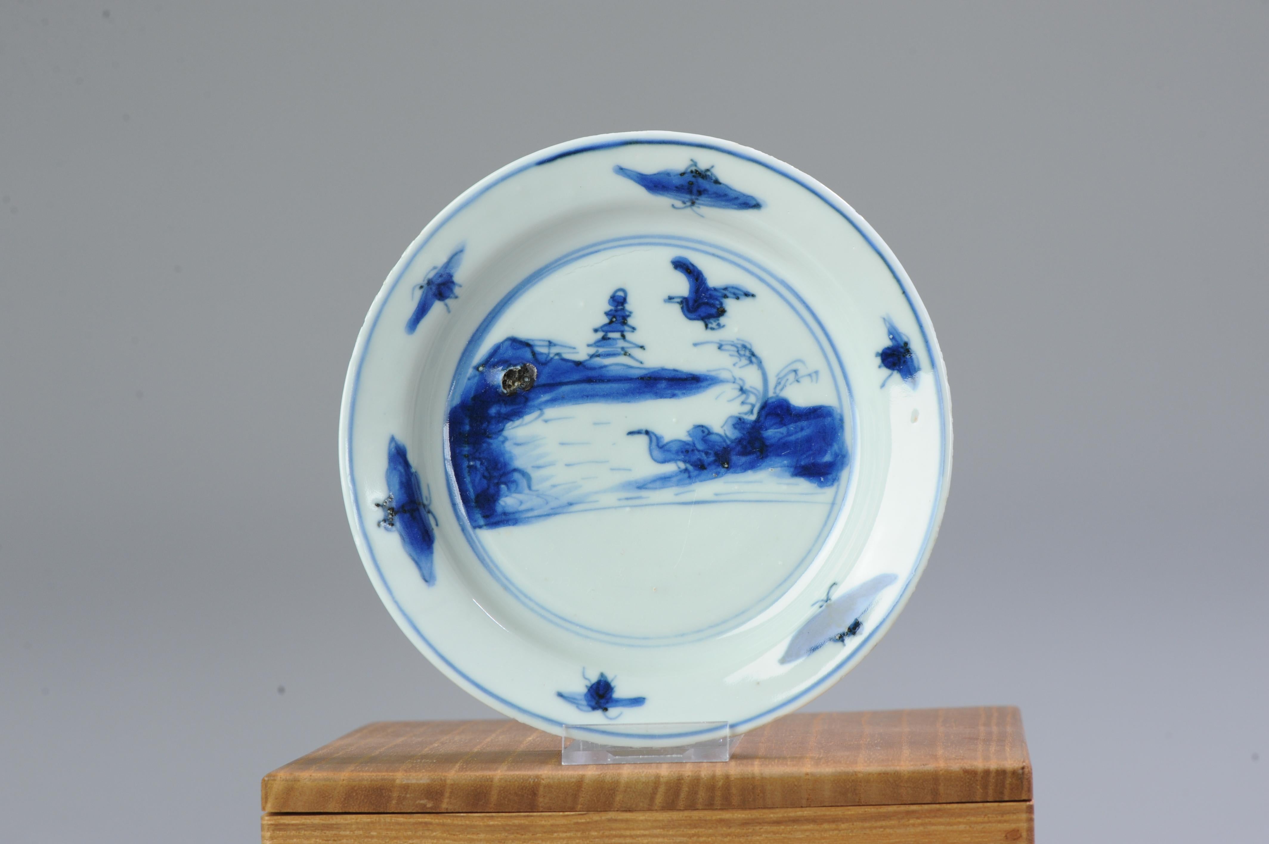 Description

A very nicely decorated Late Ming Blue and White Porcelain Dish with a landscape scene situated in two concentric circles with Ducks/Geese under a pine tree in a mountainious landscape with a pagode in the background. The moon at te