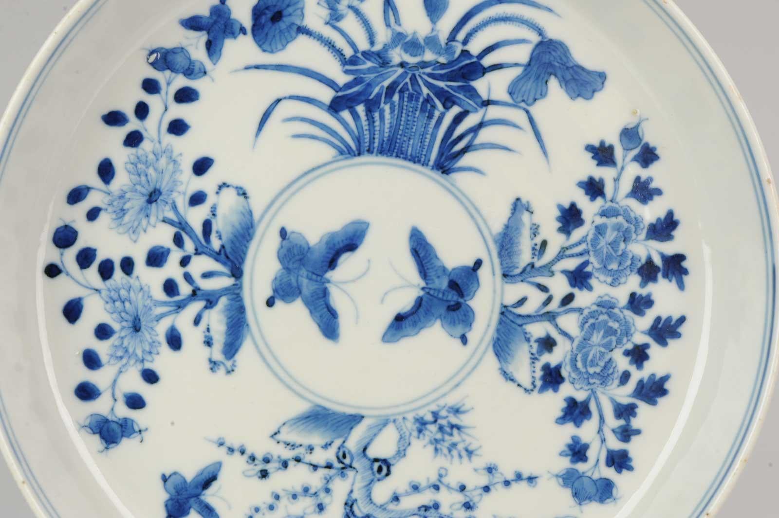 A top quality blue and white porcelain deep dish, decorated with different flowers and butterflys. Marked with 4-character mark, China, 19th century.

Pay attention to the spider web between the prunus tree.

Bleu de Hue

Chinese blue and