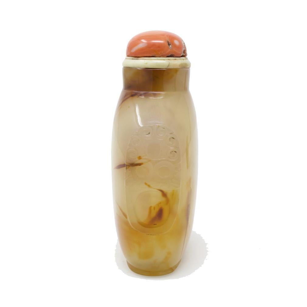 Antique Chinese Agate Master Snuff Bottle, 19th century.
Larger scale bottle of pale translucent color with varied caramel inclusions, symmetrical rectangular form with sloping shoulders, raised foot rim with rounded edges, short round neck, concave