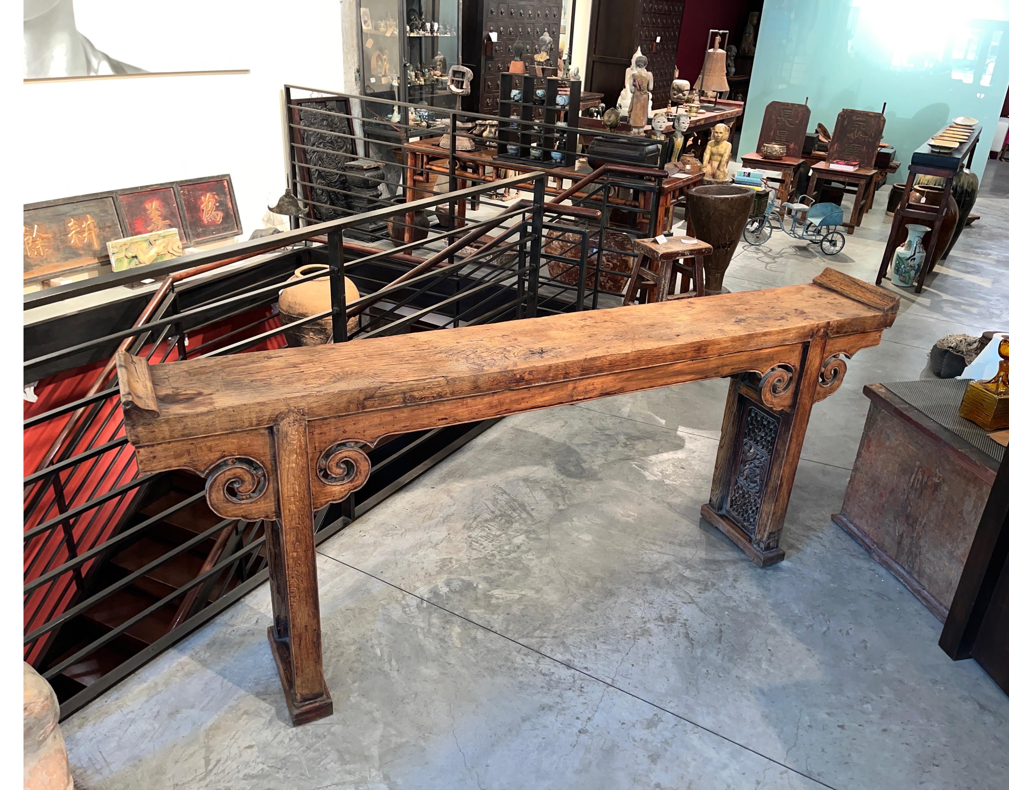 A classic  early 19th Century Chinese altar table with a solid two inch thick oak wood plank top and everted ends,  displaying a gorgeous patina.  An altar table of this scale would have been found in an important temple, presenting  an image of
