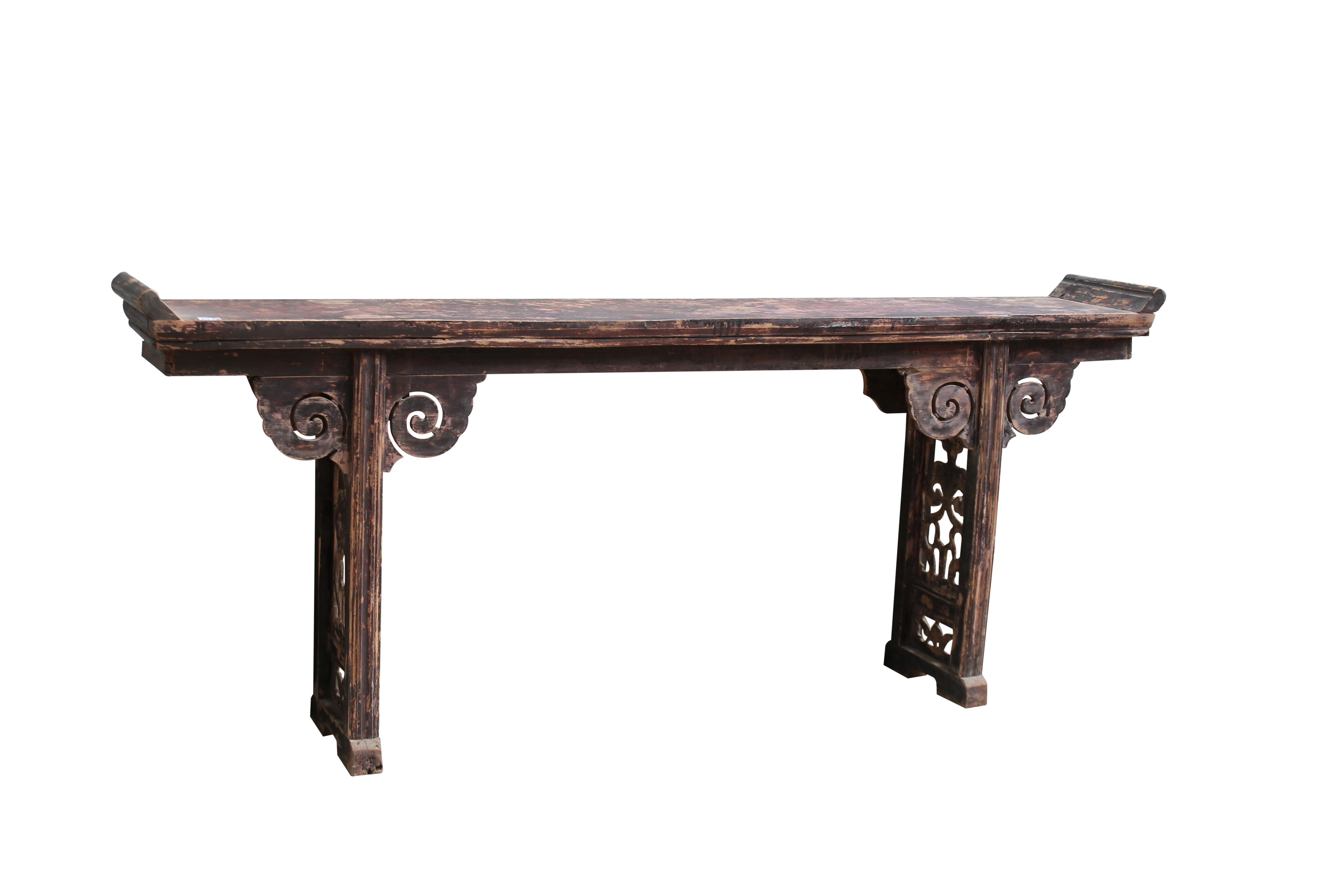 This reddish brown Chinese altar table with everted ends is adorned by a pair cloud spandrels and beautifully carved bat panel legs. This console table will make an impressive Asian console table or serving table in a living room, dining room, hall