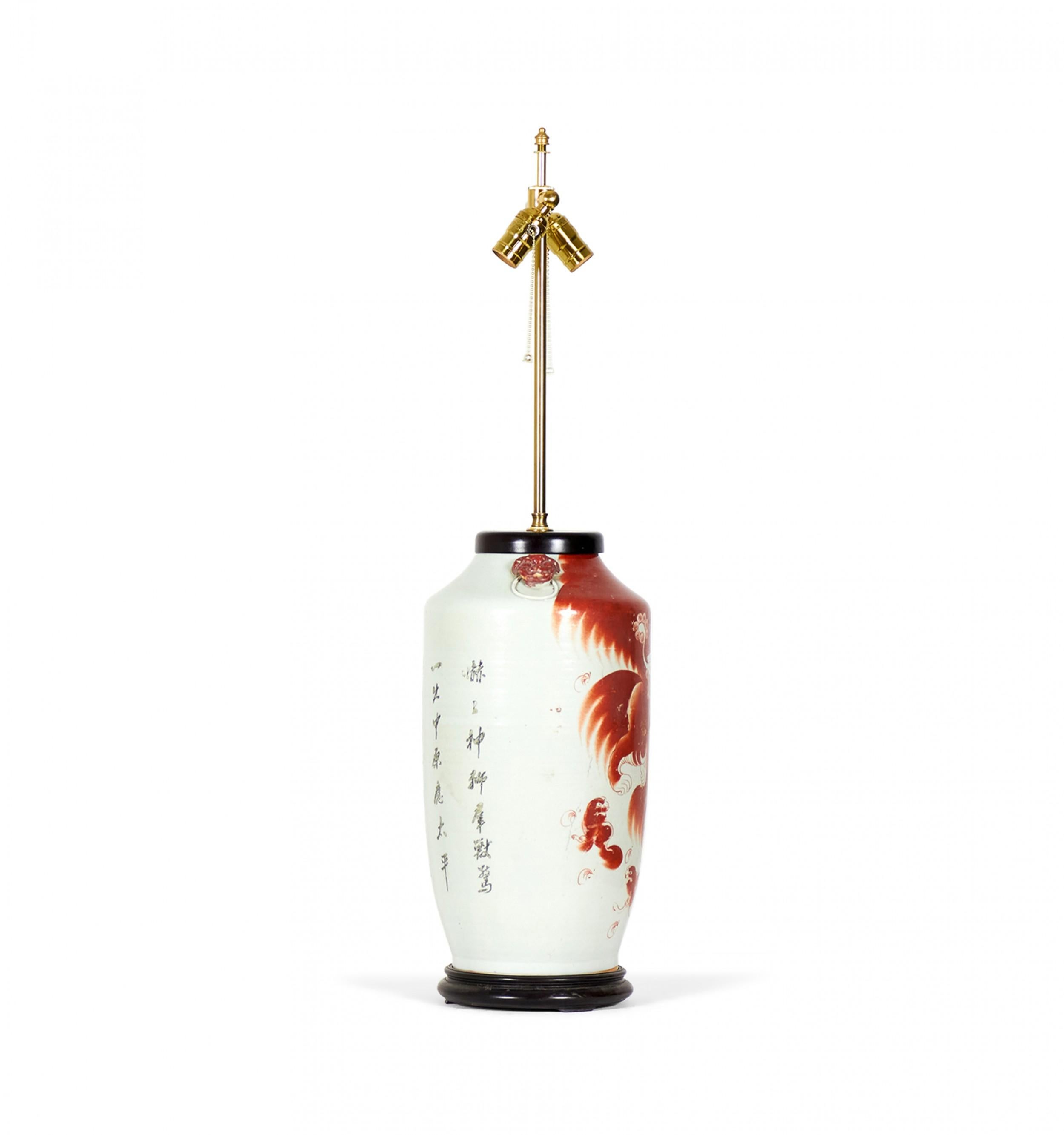 Antique Chinese table lamp made from a 19th century porcelain vase mounted with wood and brass hardware as a lamp, with an alum red Taishi Shaoshi lion design against a gray-beige background. (Similar lamp: NWL2712)

Ships without shade.