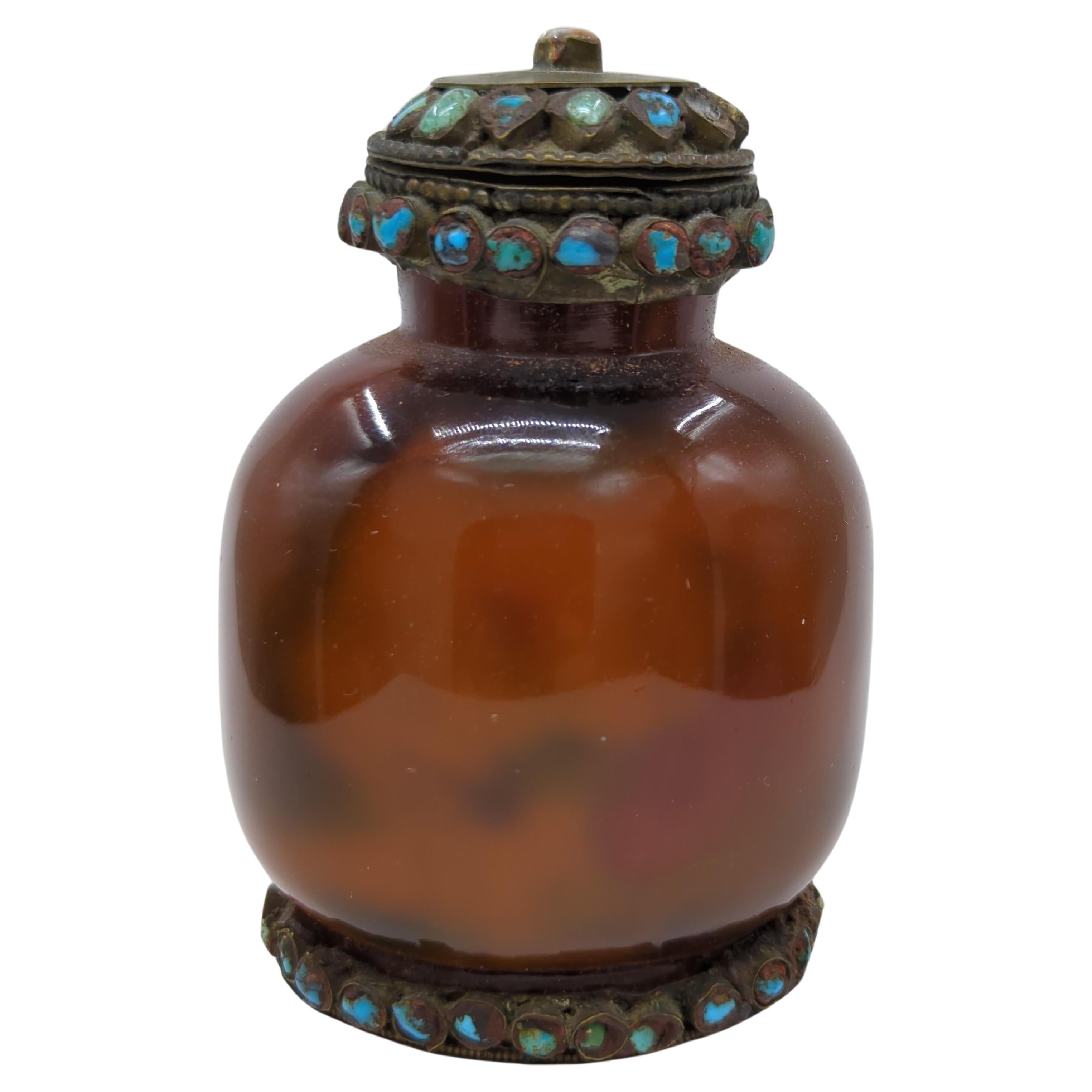 An antique Chinese snuff bottle from the late Qing period, crafted from amber glass, showcases the mysterious and intricate art of inside painting. This bottle features a continuous, delicately rendered scene of playful boys and a contemplative