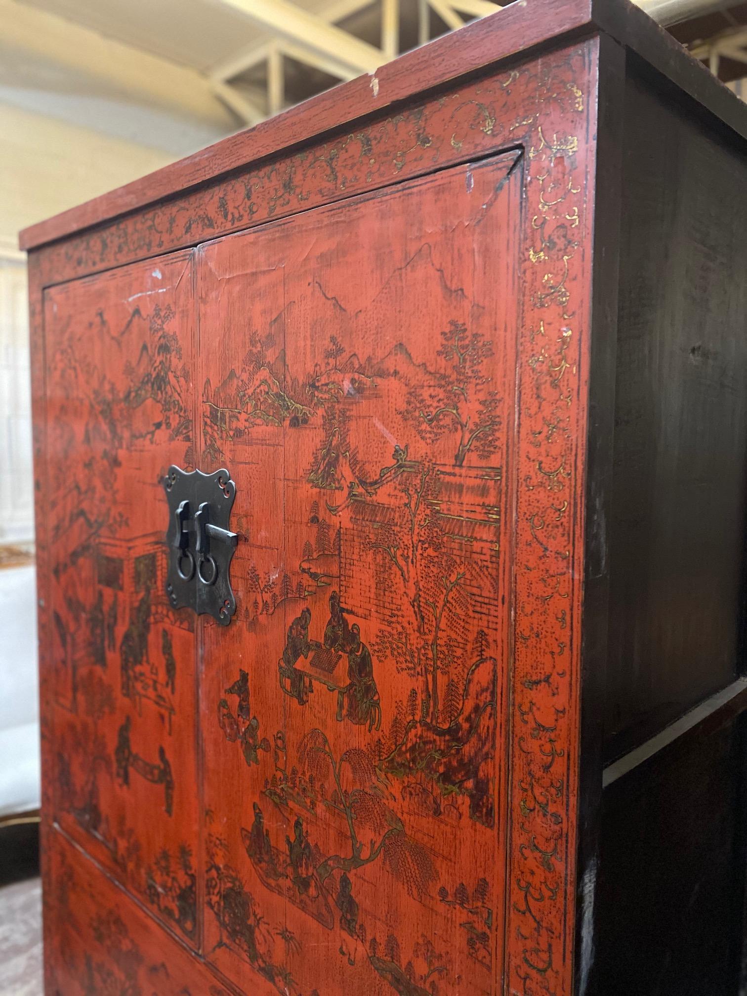 This antique Chinese armoire features a red and gold leafed exterior with wide, sturdy shelves on the interior. 

Originates from China, circa 1900. 

Measurements: 50.5'' W x 80'' H x 21'' D.