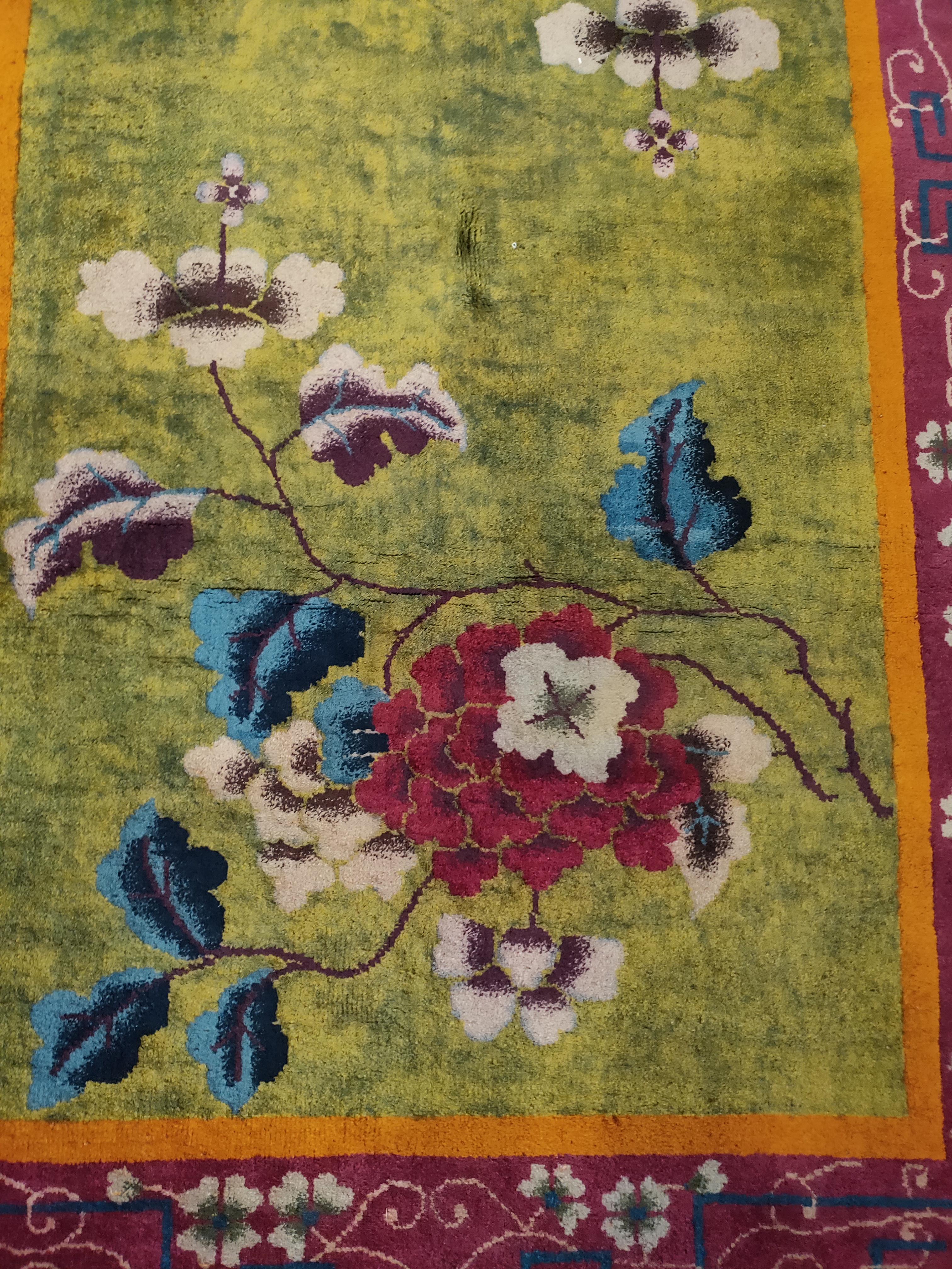 Peony sprays with giant flowers at each end of a grass green field decorate the field of this 1920s rug. A
raspberry and tendril main border attractively frames the composition. Measures: 4'0