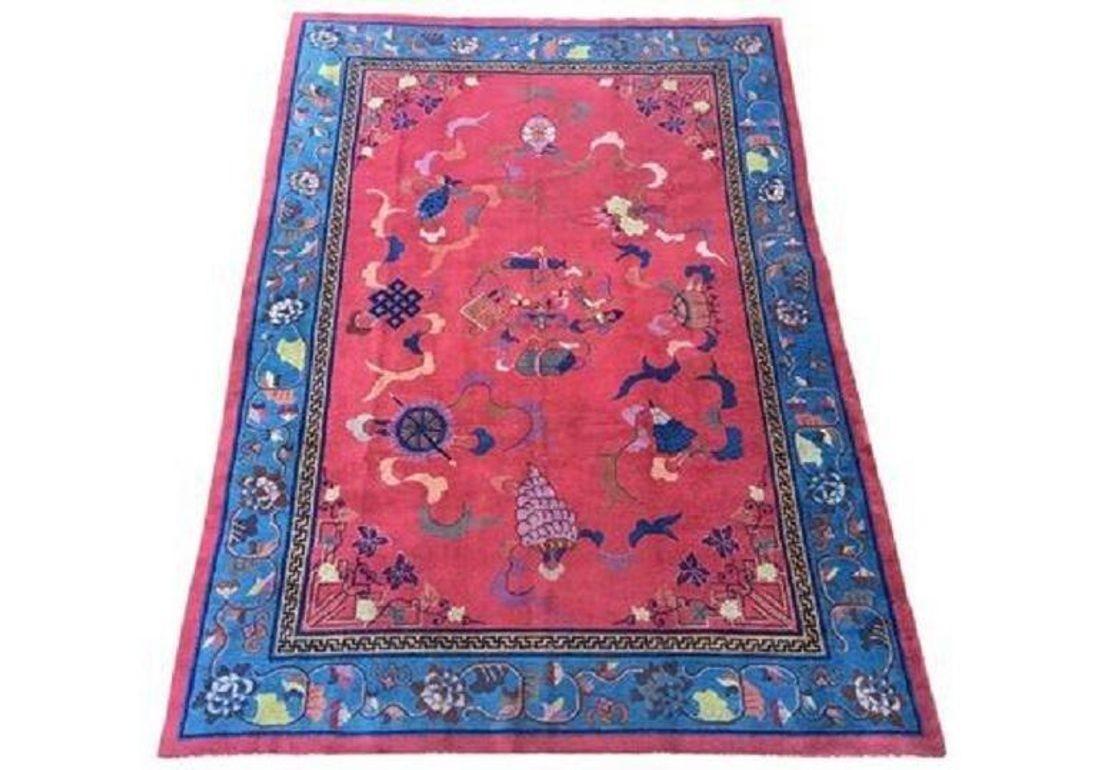 A stunning Art Deco carpet, handwoven in China circa 1920s with an unusual design depicting the eight symbols of Buddhism on a raspberry red field and blue border.
Size: 3.02m x 2.16m (9ft 11in x 7ft 1in)
This rug is in good condition with light,