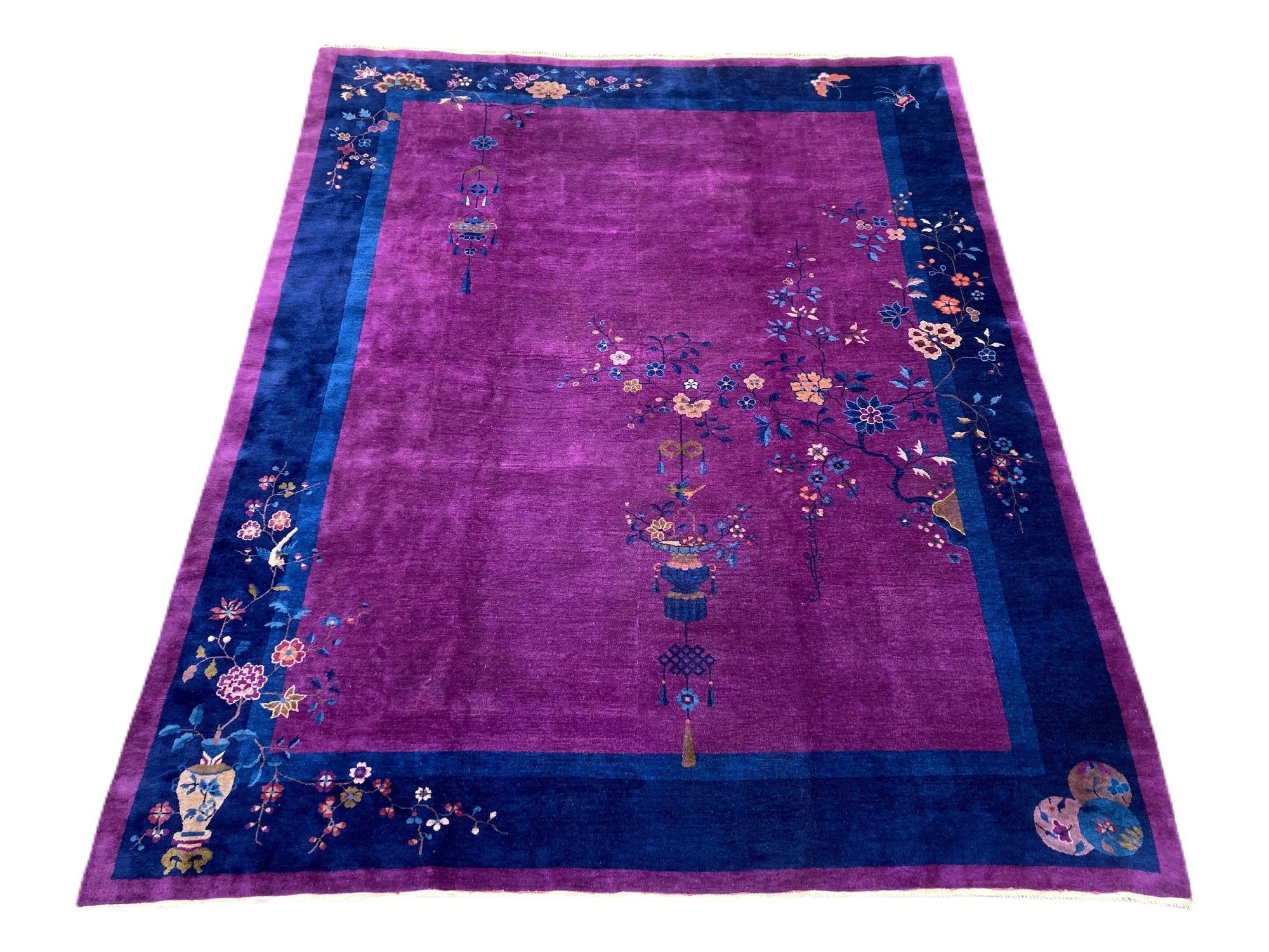 A beautiful example of an antique Art Deco carpet, hand woven in Tianjin, north-east China, circa 1920s with a simple design of floral sprays and hanging lantern on a purple field and dark indigo border.
Size: 3.43m x 2.74m (11ft 3in x 9ft)
This