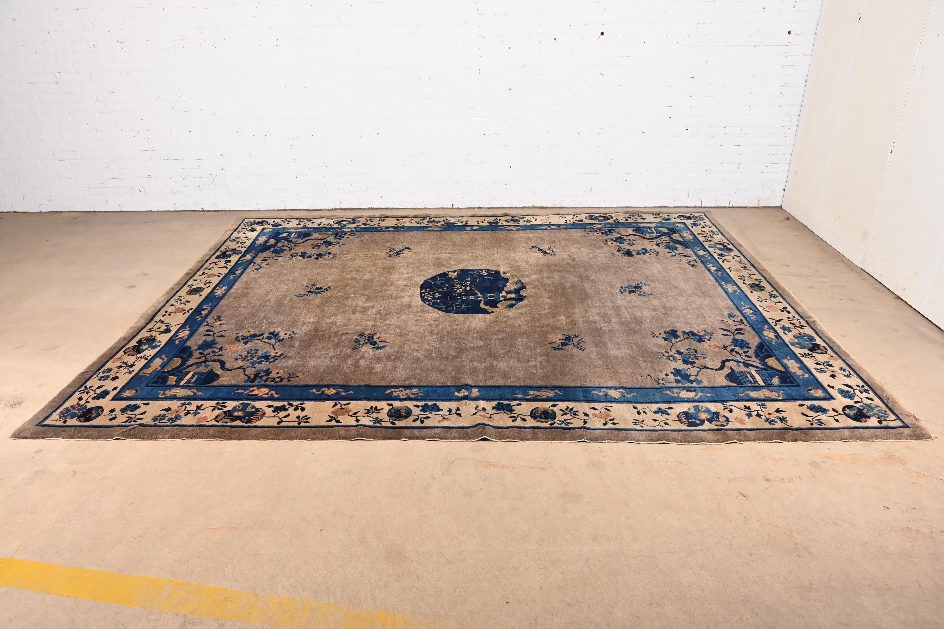 A beautiful antique hand-knotted Chinese Art Deco large room size wool area rug

China, Circa 1920s

Gray field, with blue and gray border and nice floral design with a pagoda in the center medallion.

Measures: 9'3