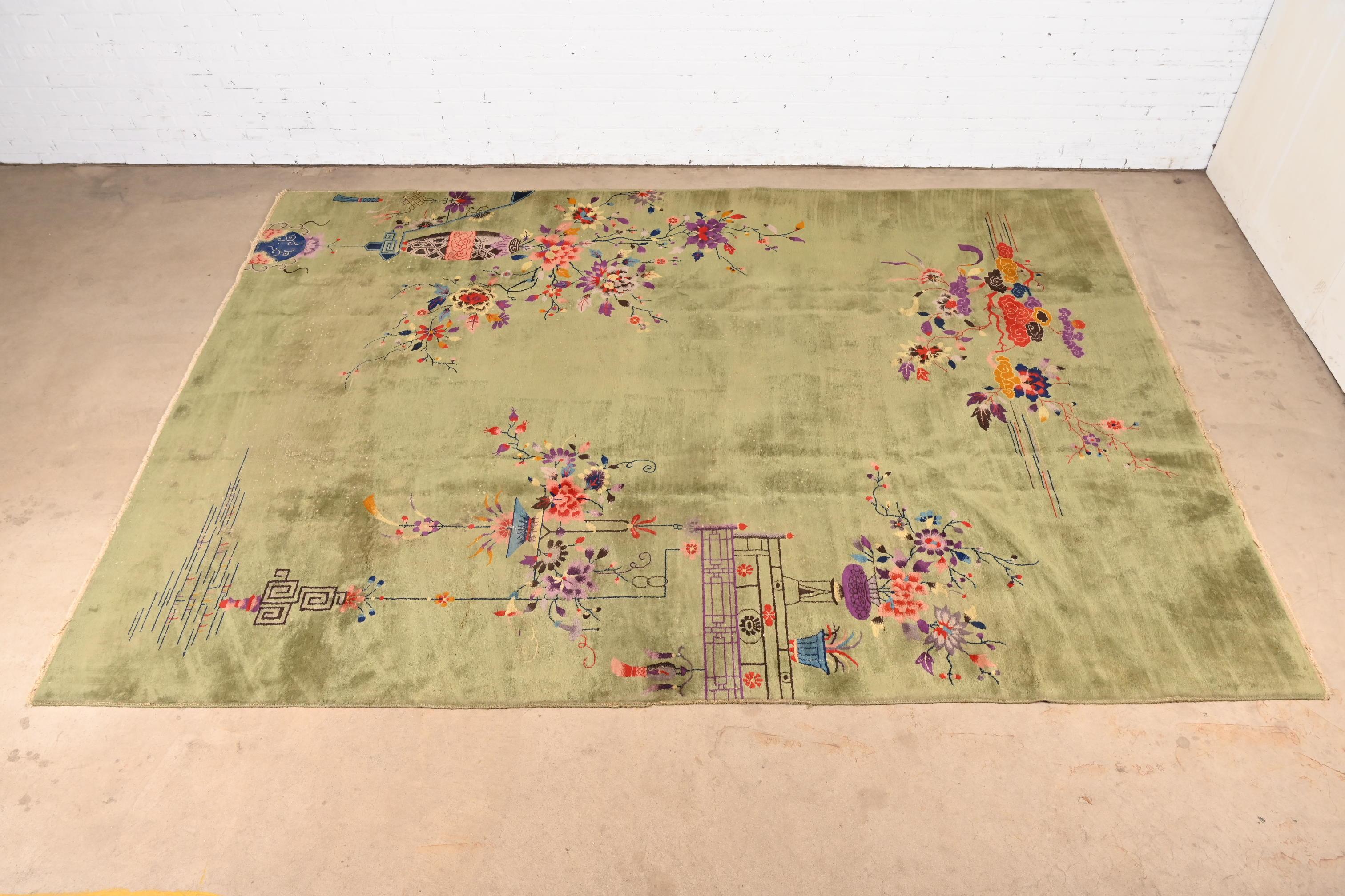 A beautiful antique hand-knotted Chinese Art Deco large room size wool area rug

China, Circa 1930s

Light green field, with a vibrant multi-colored floral design.

Measures: 9'1