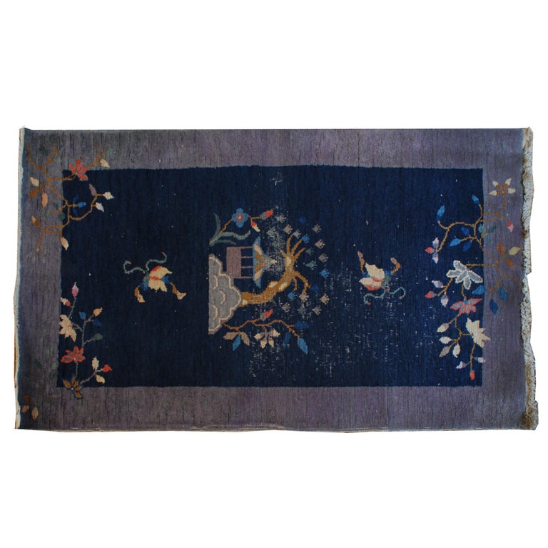 Taking months or even years to create, this handwoven carpet is made of the softest wool dyed with natural and vegetable dyes, including indigo that produces the luscious, midnight blue ground. Made around 1920, the rug has the simple, modern