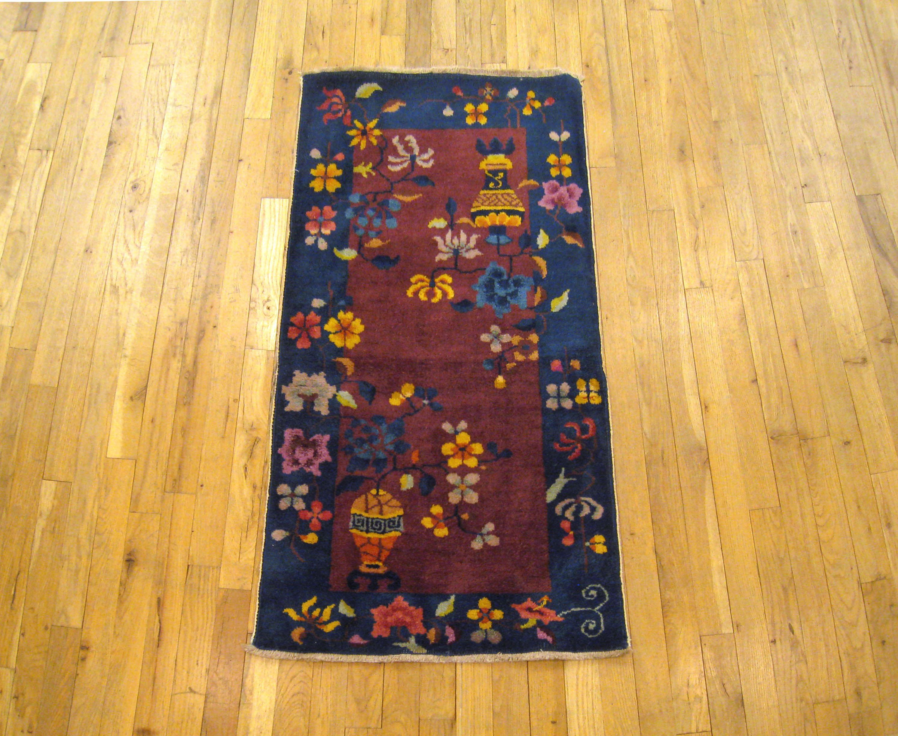 An antique Chinese Art Deco oriental rug, size 4'0 x 2'0, circa 1920. This lovely hand-knotted antique carpet features various traditional Chinese motifs in the central field, including uniquely rendered vases with flowers. Handmade, with short to